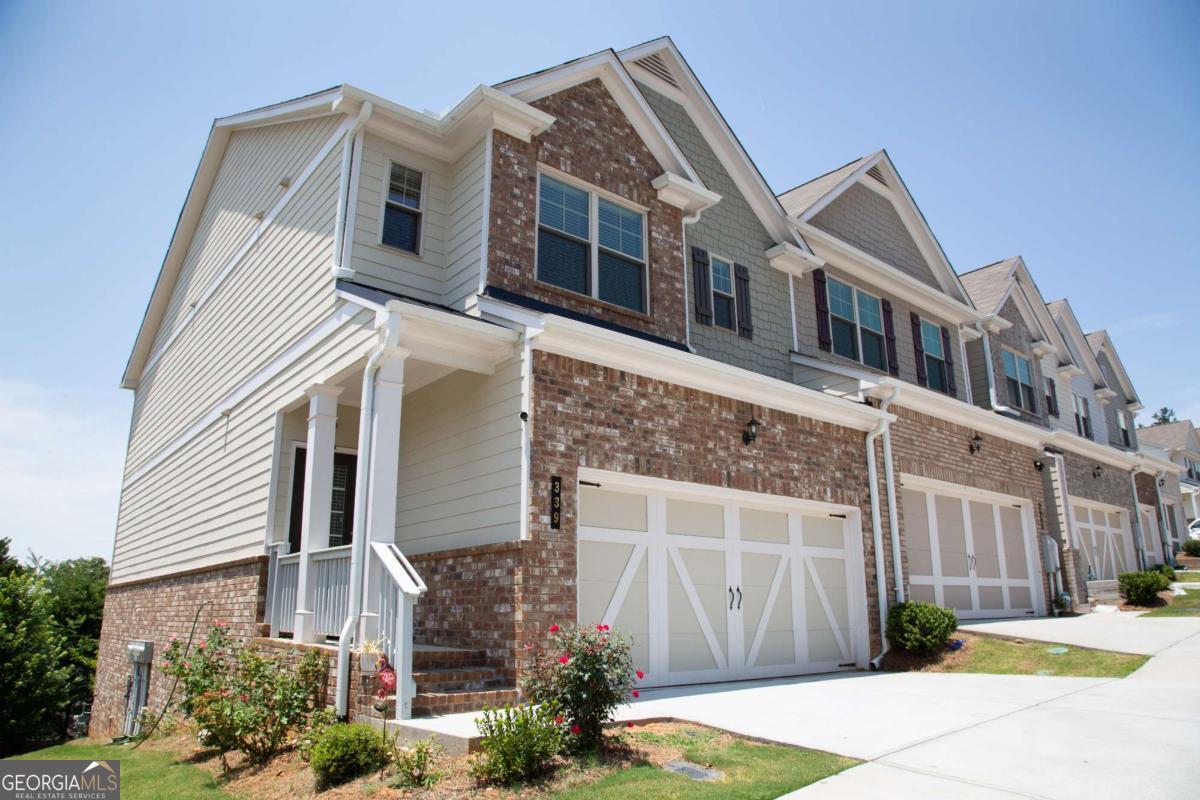 Big, Beautiful, East Facing, End Unit Townhome with Finished Basement Near Amazing Downtown Woodstock! Incredible Panoramic Views off Private Back Deck and so much more! High End Finishes and Open Floor Plan! Spacious Kitchen includes Granite Island/Breakfast Bar, Gorgeous Granite Counter Tops, Stainless Steel Appliances, 42 inch Cabinets; Totally Open to Lovely Dining Area and Fireside Family Room Space! Absolutely Incredible Views from the Family Room, Dining Area, and All Back Windows! Spacious Master Suite/Bath features Big Walk In Closet, Trey Ceiling, Tiled Shower, Separate Garden Tub, Double Vanities, and more. All bedrooms offer plenty of space! Finished Downstairs/Basement is wide open space! Priced Below Appraisal and Among the Very Few Townhomes in the Community with Finished Basements! Easy access to shopping, and not far from Fabulous Downtown Woodstock! Live the dream lifestyle of elegant and affordable privacy yet near entertainment, restaurants, and more! If you like affordability, luxury, space, scenery, and convenience, this is the perfect place for you!!!