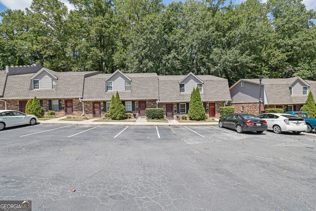 This home is a hidden gem! Nestled in a quiet, tucked-away community right in the heart of Smyrna, this charming 2 bedroom, 1.5 bath condo offers the perfect blend of tranquility and convenience. Step inside to find a separate dining room, an updated kitchen with new cabinets, countertops, and backsplash, and LVP flooring throughout the main level. Enjoy the natural light from brand-new windows and a sliding glass door that leads to a private back patio overlooking peaceful wooded views. Fresh paint throughout and a beautifully renovated tile shower in the main bath add to the move-in ready appeal. You'll love the ample parking, a great community pool, and a location that can't be beat-just minutes from I-75, The Battery/Braves Stadium, Cobb Galleria, Cumberland Mall, and tons of dining and entertainment options.