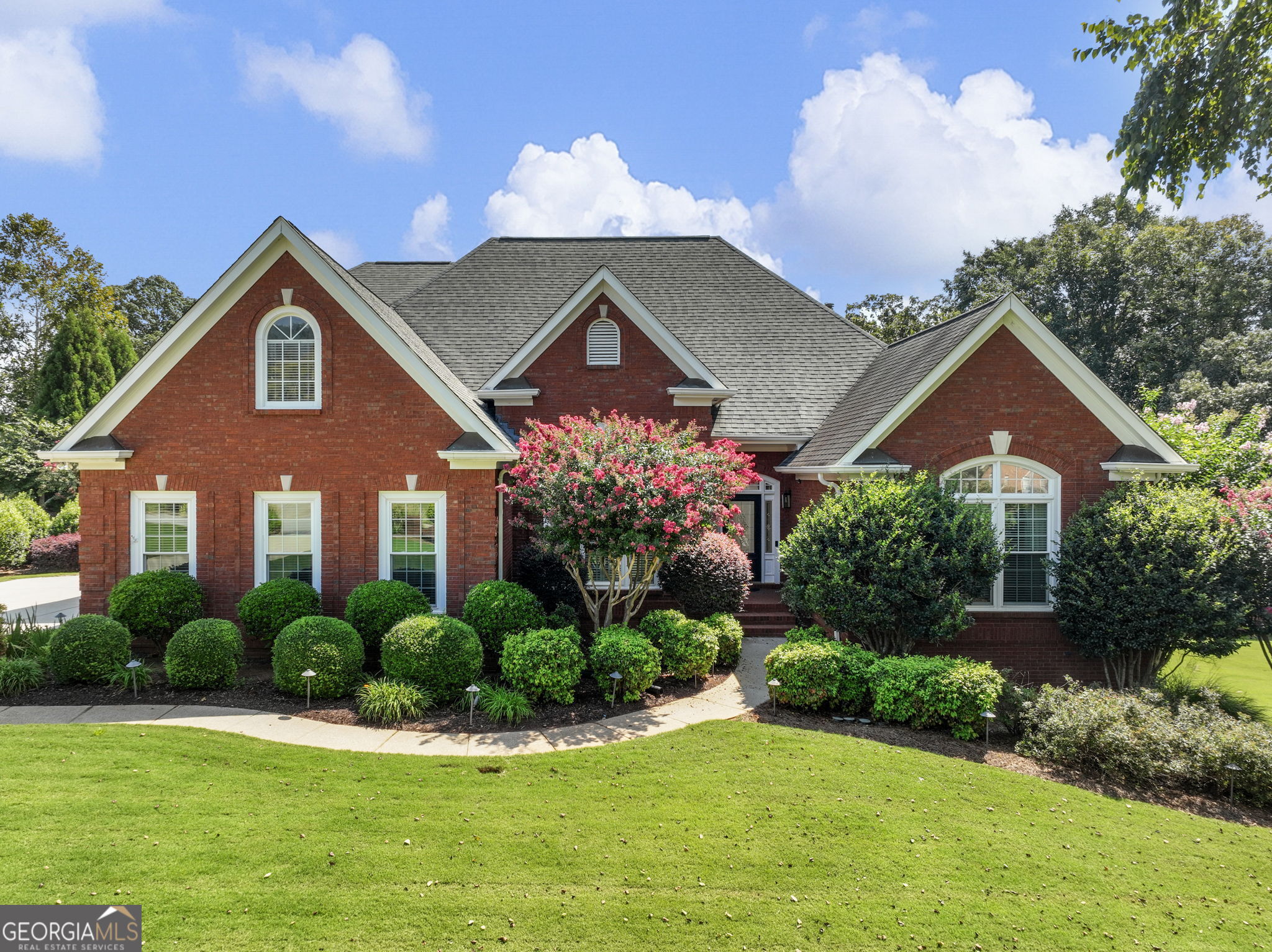 EXQUISITE 4-SIDED BRICK ESTATE HOME NESTLED ON OVER AN ACRE IN A SMALL SUBDIVISION WITH LOW HOA FEES AND ONLY ONE STREET, OFFERING PRIVACY AND EXCLUSIVITY. THE MAIN LEVEL SHOWCASES A SPACIOUS OWNER'S SUITE WITH A SPA-INSPIRED EN SUITE BATH FEATURING A SOAKING TUB AND SEPARATE SHOWER, ALONG WITH TWO ADDITIONAL SECONDARY BEDROOMS. A STUNNING FORMAL DINING ROOM AND AN ELEGANT GREAT ROOM WITH SOARING CEILINGS OVERLOOK THE PICTURESQUE BACKYARD, WHILE THE OPEN-CONCEPT KITCHEN SEAMLESSLY FLOWS INTO THE KEEPING ROOM WITH A COZY FIREPLACE-PERFECT FOR GATHERINGS BOTH LARGE AND SMALL. UPSTAIRS OFFERS AN ADDITIONAL BEDROOM, FULL BATH, AND A VERSATILE FLEX ROOM IDEAL AS A SECOND MASTER SUITE. THE FINISHED TERRACE LEVEL PROVIDES EXCEPTIONAL SPACE FOR MULTI-GENERATIONAL LIVING, COMPLETE WITH A FULL KITCHEN, BATHROOM, GAME ROOM, FLEX ROOMS, AND DIRECT ACCESS TO THE POOL. OUTDOOR LIVING IS AT ITS FINEST WITH A SPARKLING SWIMMING POOL, STONE FIREPLACE, EXPANSIVE DECK, AND PATIO, CREATING A TRUE RETREAT. CAR COLLECTORS WILL APPRECIATE THE SECOND GARAGE IN THE BASEMENT WITH A BOAT DOOR, OFFERING GENEROUS SPACE FOR MULTIPLE VEHICLES. IDEALLY LOCATED JUST MINUTES FROM SHOPPING, DINING, MEDICAL FACILITIES, AND WITH CONVENIENT ACCESS TO I-85 AND I-985, THIS REMARKABLE PROPERTY OFFERS BOTH LUXURY AND LIFESTYLE.