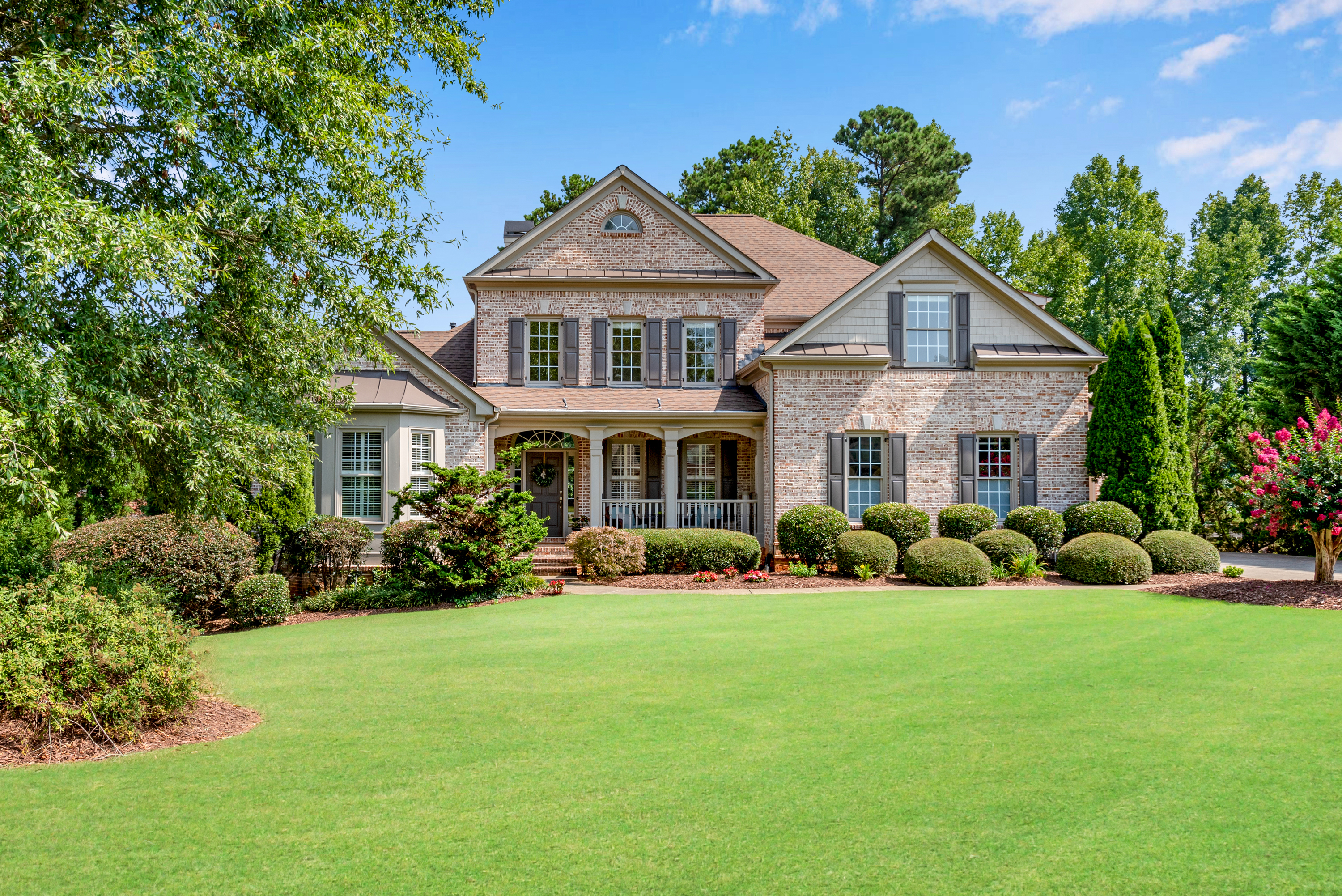 Sited on a large, flat corner lot, this elegant MASTER ON MAIN 5 bedroom, 6.5 bath home located in highly sought after Lake Astoria has it all! The grand two story entryway welcomes you into this light-filled home with elegant formal living room, new interior paint and recently refinished hardwood floors throughout. The gourmet kitchen is the heart of the home and features beautiful, white custom cabinets and backsplash, neutral granite counters, breakfast bar and SS appliances. This executive home is truly beautiful - perfect for entertaining and the many windows and natural light make it warm and inviting! The primary owner's retreat is spacious - it features hardwood floors and bay window! The master bath has dual vanities with granite counters, frameless shower & whirlpool tub. FOUR generously sized secondary bedrooms with en suite bathrooms on the second level. The large FINISHED BASEMENT offers a bath with LVP floors, recreation room/office, and family room. The workshop and storage areas are fully heated and air-conditioned. Exterior has recently been painted, and the roof is less than five years old. The large .68 acre corner lot offers a flat, beautifully landscaped backyard surrounded by a wrought iron fence - there is even room for you to add a pool! The Lake Astoria community features loads of opportunities to socialize with neighbors - Cornhole games and pickleball, back to school social, July 4th fireworks - all just part of this outstanding community. Amenities are an Olympic-sized swimming pool, lighted tennis courts, playground, pavilion, clubhouse, outdoor fireplace, ball/soccer field, 18-acre stocked lake and community dock. The newly-opened Cumming City Center with brewery, Lou Sobh amphitheater for outdoor concerts, restaurants and upscale shopping is a five minute drive. Lake Astoria is close to Sawnee Mountain - the greenway is just a few minutes away and offers a great opportunity to ride bicycles or go for a run. Close to GA 400, Northside Hospital, Lake Lanier, shopping, restaurants, parks and green space and the North Georgia mountains/wineries.