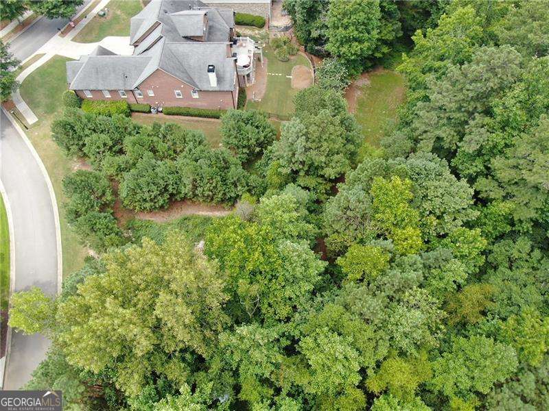 Nestled between two peaceful cul-de-sacs in a prestigious high-end golf club community just outside Atlanta, this nearly half-acre lot offers the perfect canvas for your dream home. The property boasts a serene and private setting, enhanced by a natural wooded barrier on two sides, providing both beauty and seclusion. Located on a quiet street with minimal traffic, this spacious lot combines tranquility with access to upscale amenities, making it an exceptional opportunity for refined living. This is an ideal lot for a walk out basement. Enjoy the best of Cobb County at your fingertips.