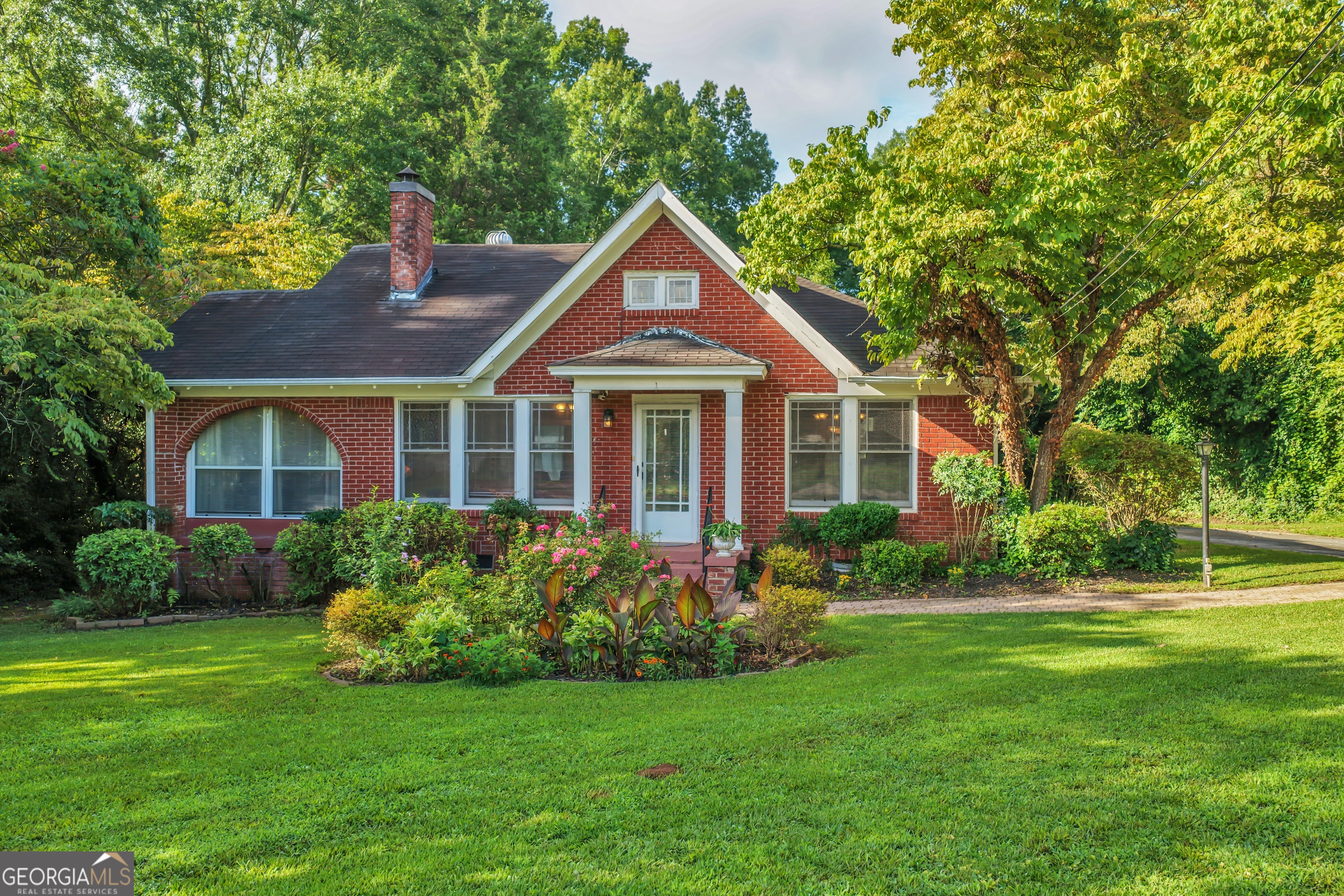 "This home has masterful features that you can not find in a world of new construction." -Architect Historical Designs Magazine This 4 bedroom / 2 bathroom historic home has the benefits of solid old-style construction and modern upgrades. Built in 1932 by the then-mayor of Jonesboro and professional home builder who put his heart and soul into this custom home, it has been completely updated while preserving the the original oak hard wood floors, cedar 2x4s, glass door knobs, antique door latches, skeleton keys, claw foot soaking tub, custom antique crown molding, vintage built in cabinetry, and even secret rooms! Updates include a remodeled kitchen with granite counter tops, custom cabinets, tile floor with a matching back splash and stainless steel side by side refrigerator, dishwasher, garbage disposal and black cook top. It also has all new air ducts with a Carrier AC Furnace & coil with media filter to ensure quality air flow. There is a separate structure that is ready to use as an in-law suite with its own kitchen, living room, bedroom, laundry room (washer and dryer stay) and screened porch. Additionally, the two bedrooms at the back of the main house can be closed off for complete privacy with a sitting area, private entry and screened porch. Excellent for multigenerational family, but the possibilities are endless. The expansive lot has been carefully landscaped and is framed by mature dogwood trees, a large fig tree, giant hydrangea, azaleas, roses, lilacs, nandina bushes, and over 2,000 bulbs including tulips, daffodils and iris of numerous varieties. Conveniently located one block from the attractions in downtown Jonesboro, a park that hosts summer concerts, easy access to public transportation, and less than 10 miles from the airport, this one-of-kind home will not last long.