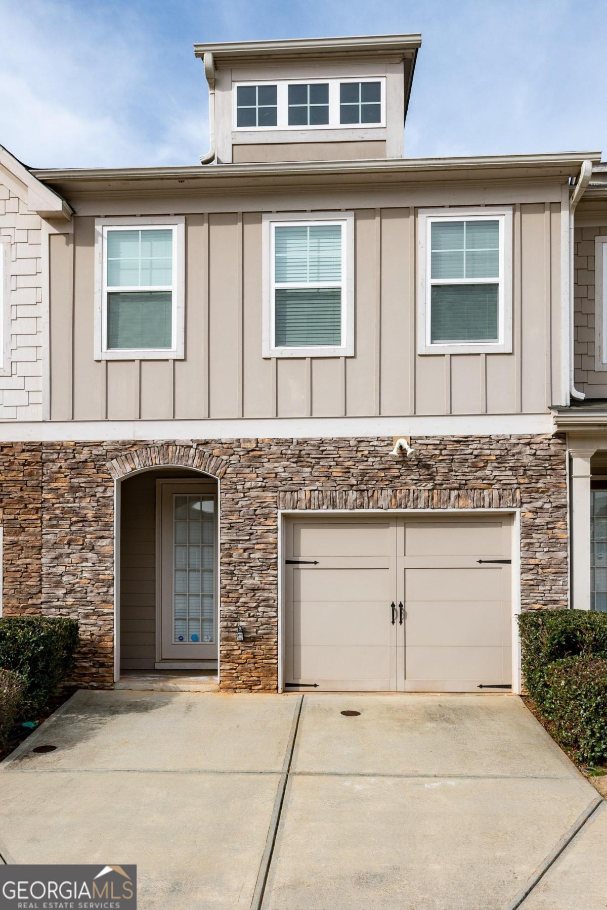 Welcome to this beautifully maintained townhome, perfectly situated in the gated community of Longview Walk in Decatur, GA. Designed for modern living, this residence blends comfort, style, and functionality in every detail. Step inside and be greeted by warm hardwood floors and an open-concept main level filled with natural light. The spacious living and dining areas provide the ideal setting for entertaining or enjoying everyday life. The chef's kitchen is thoughtfully appointed with 42-inch custom cabinetry, granite countertops, tile backsplash, and a breakfast bar-along with sleek black and stainless steel appliances (including a washer and dryer) and a walk-in pantry for ample storage. The cozy living area features a fireplace, creating a perfect ambiance for quiet evenings. Upstairs, retreat to a generous primary suite complete with a spa-inspired ensuite bathroom featuring a double vanity, soaking tub, and separate shower. Two additional bedrooms and a full bath offer flexibility for family, guests, or a home office. Step outside to enjoy your private, fenced backyard-ideal for outdoor dining, weekend barbecues, or simply unwinding in your own peaceful space. This isn't just a home-it's a lifestyle. Thoughtfully maintained and move-in ready, this townhome offers the perfect blend of elegance, convenience, and comfort in a secure, sought-after community.