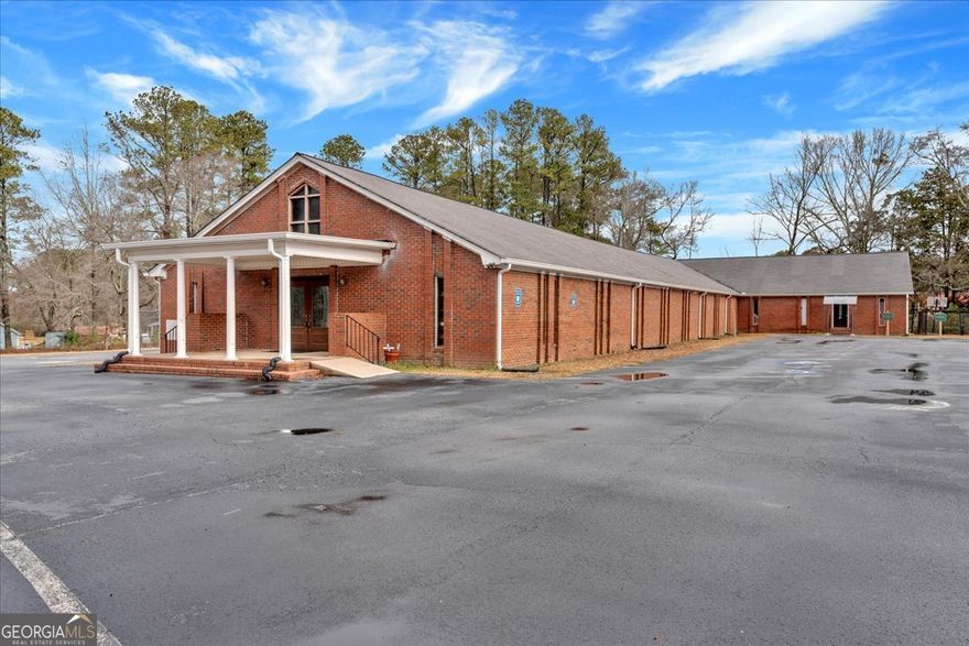Situated in the rapidly growing commercial hub of Villa Rica, 35 McCurdy Rd offers an exceptional opportunity for corporate, medical, or institutional buyers. This expansive 3.94-acre property, featuring a 9,680 sq. ft. building, provides ample space for expansion, redevelopment, or adaptive reuse. Directly across the street from Tanner Medical Center Villa Rica and adjacent to Tanner Willowbrooke, the location ensures high visibility and ease of access for medical offices, corporate headquarters, or large-scale religious institutions. The property is easily rezoned for commercial or medical use, making it a seamless transition for buyers looking to develop in a high-demand area.    Beyond the existing structure, the size of the lot opens up endless possibilities, whether for additional medical office buildings, a corporate campus, or expanded facilities to support institutional or commercial needs. The property also includes a large, paved parking lot with 60 spaces, providing immediate accessibility for high-traffic operations. With room to expand and flexibility in use, this site is well-positioned to support a variety of commercial, healthcare, or professional developments. Villa Rica's ongoing growth and the property's strategic location near major healthcare facilities and business corridors make this a prime investment in West Georgia's evolving commercial and medical landscape.