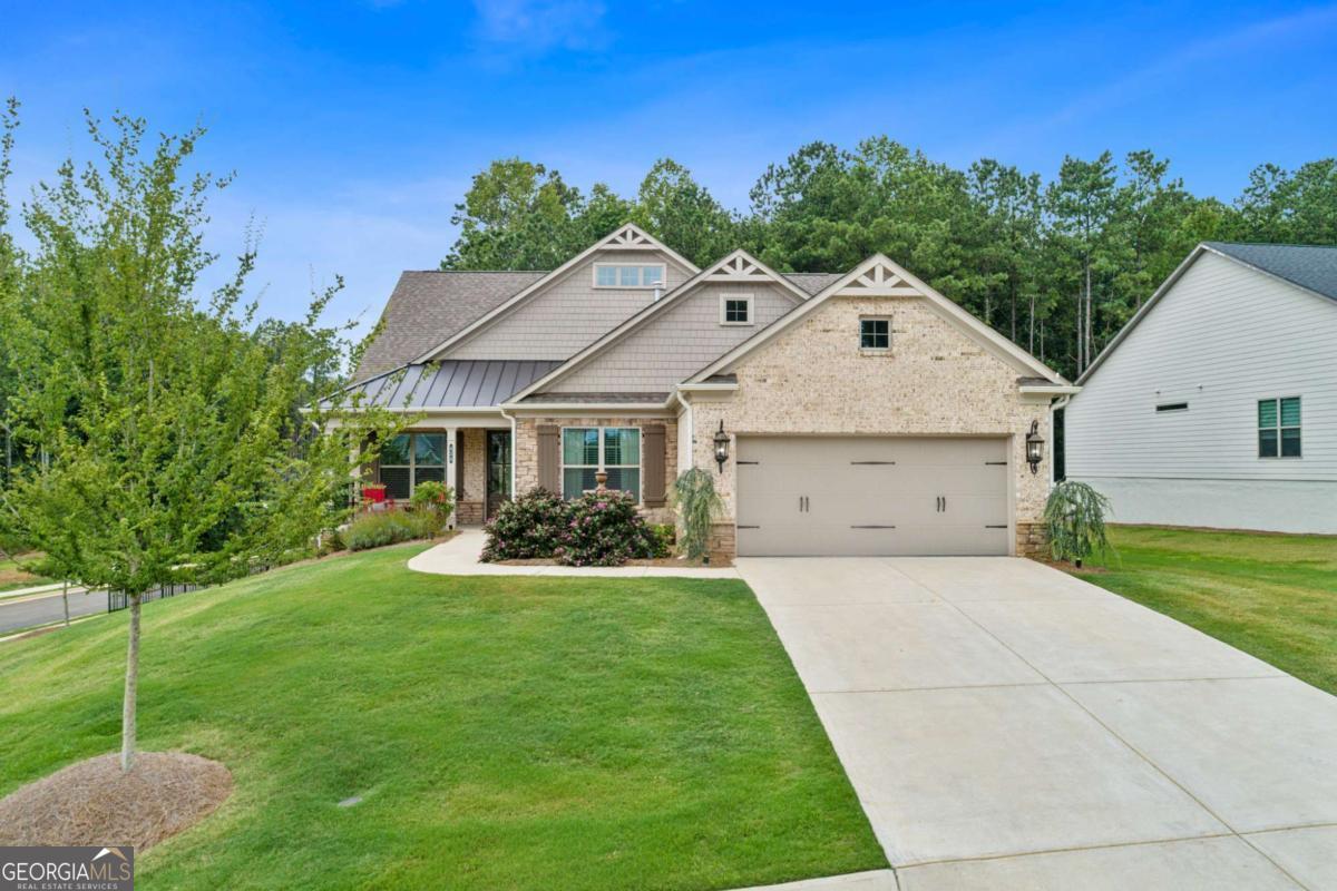 Explore a unique opportunity in the world of new construction! Situated within the prestigious Soleil Belmont Park community in Canton, this residence is conveniently located just minutes from the delightful Downtown Canton and a short drive to Atlanta. Enjoy the benefits of a brand-new home, equipped with numerous high-end features already included. Welcome to this exceptional 55+ premier community developed by Patrick Malloy. This remarkable premium lot, no longer available within Soleil, offers a fenced area suitable for a potential pool, coupled with a finished basement. This exquisite, better-than-new home provides resort-style amenities within a premier gated active adult community, ready for immediate occupancy. With nearly $200,000 in upgrades and finishes, this stunning single-level home with a fully finished basement boasts a spacious, fenced backyard, perfect for your furry friends-all at a competitive price. The interior showcases a beautiful design, featuring hardwood flooring throughout, an expanded owner's suite, designer touches, upgraded bathrooms, and elegant lighting. Bathed in natural light, the home features an ideal open-concept living layout, complemented by exceptional outdoor living spaces. Meticulously designed, this residence includes all the sought-after features you would choose if building from scratch, eliminating the wait. The open floor plan highlights a chef's island kitchen that seamlessly flows into the fireside family room, with a sliding wall of windows leading to the covered deck area-ideal for entertaining guests and family. The spacious owner's suite boasts a spa-like bathroom, while the second bedroom and guest/bonus room share a hall bath. The finished basement is sure to impress your visitors and is perfect for extended gatherings. An additional sunlit bedroom with an elegant full bath and a steam shower adds a luxurious touch for those relaxing moments. This community epitomizes resort-style living with unmatched amenities, including 24/7 gated access, an award-winning clubhouse, walking trails, a dog park, swimming pool, pickleball, and tennis courts! Daily activities are unbeatable-enjoy coffee with friends, take a cooking class, or unwind in the community gardens. Additional features include a monitored home security system, weekly lawn maintenance for both front and back yards, weed control, fertilizing, and basic cable service provided by the HOA. Experience the freedom of a "lock and leave" lifestyle, allowing you to travel with peace of mind.