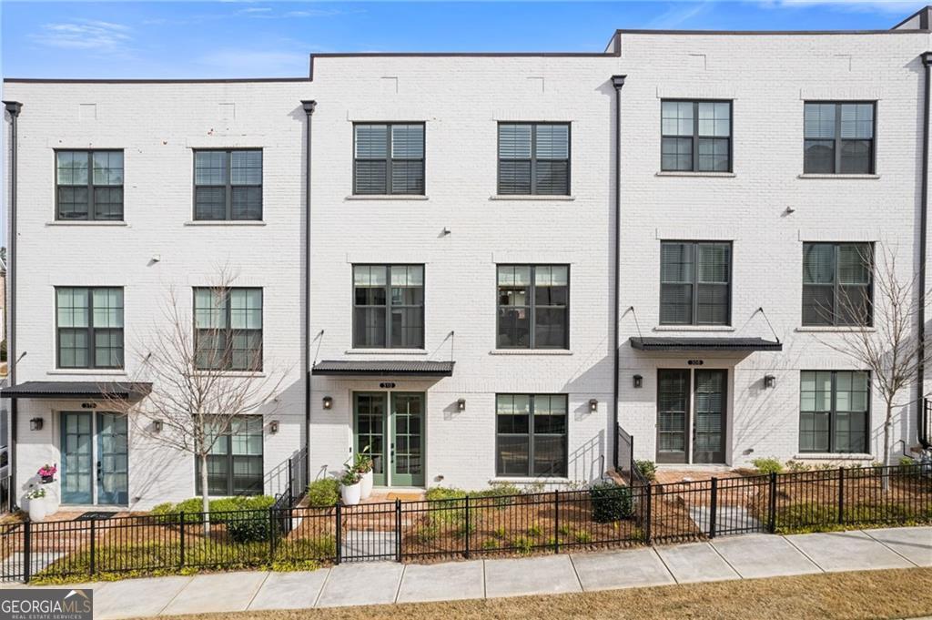 Spacious, Stylish, and Steps from Downtown Alpharetta - This beautifully upgraded three-story townhome truly lives like a single-family home. From the generous open-concept layout to the designer finishes throughout, every detail offers comfort, functionality, and timeless styleCoright in the heart of Alpharetta. At the center of the home is a spacious main floor where the open layout seamlessly connects the kitchen, dining area, and family roomCoideal for both everyday living and entertaining. The gourmet kitchen is loaded with upgrades, including high-end quartz countertops, an oversized island with seating for 4Co5, a coffee bar, upgraded cabinet hardware, and designer pendant lighting. Hardwood flooring and custom window treatments flow throughout, while a painted brick fireplace wall adds charm and warmth. Additional hardwired sconces in the living room and powder room elevate the lighting design, and the dining area pops with designer wallpaper. Step outside to a large covered deckCoperfect for enjoying your morning coffee or entertaining guests. Upstairs, the ownerCOs suite offers a peaceful retreat with custom paint, upgraded lighting, and elegant molding in the bath. The generously sized primary bathroom features a spacious, fully tiled walk-in shower, two separate vanities, and custom LED mirrors framed with rich wood trimCogiving the space a high-end, spa-like feel. The suite also includes an expansive custom walk-in closet, offering both function and style with thoughtful organization and ample storage. Two additional bedrooms, a full hallway bath with upgraded tile, lighting, and mirror, and a conveniently located laundry room complete this level. Custom plantation shutters and upgraded hardwood floors carry throughout for a consistent, upscale look. The entry level features a flexible fourth bedroom with custom closet shelving and upgraded lightingCoideal for a guest suite or home office. Additional highlights include upgraded hardwood flooring, custom window treatments, and statement molding along the staircase wall. The large two-car garage (with 2 separate doors to easily fit 2 cars) includes custom built-in storage, offering extra space for organization and convenience. The Maxwell community includes resort-style amenities such as a pool, clubhouse, two firepit areas, and a bocce ball court. Just a short walk away is The Maxwell Retail district, offering great restaurants and shopping. YouCOll also enjoy direct access to the Alpha LoopCoa 12-foot-wide urban trail network connecting Downtown Alpharetta, Avalon, the North Point Eco District, and Northwinds. Conveniently located just one mile from GA-400, this townhome offers easy access for commuting while placing you steps from the best of Alpharetta living.