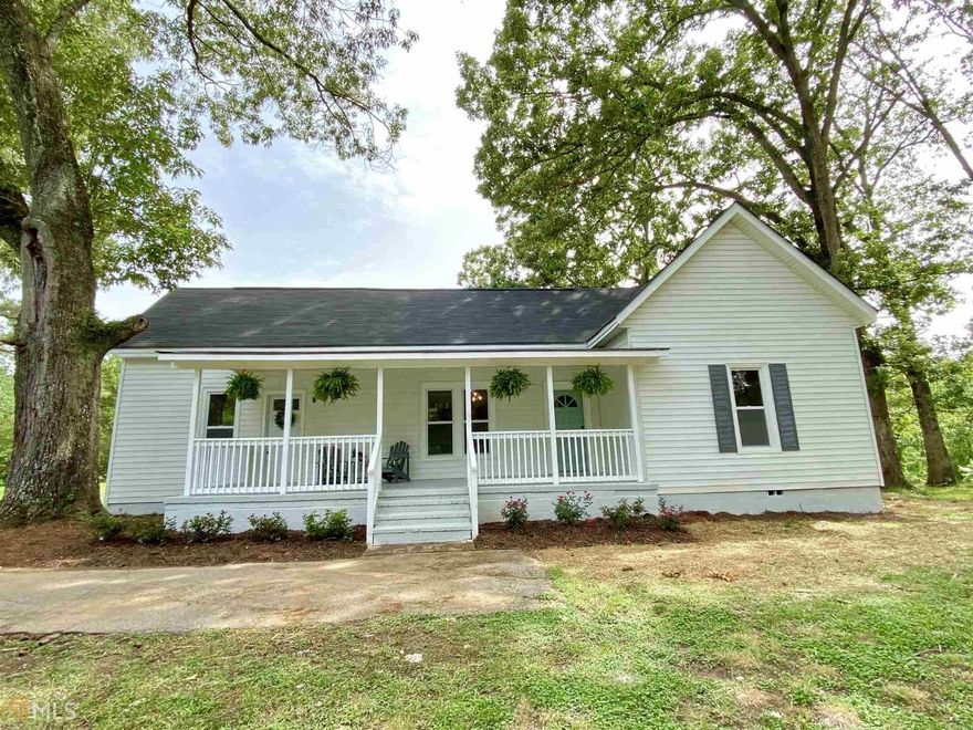 True Southern Farmhouse built in 1930 on over 1 acre private lot.  Historical Integrity has been preserved with original and beautifully restored hardwood floors.  Step into your farmhouse and see the gorgeous 10 foot ceilings with beams in the living room , 2 fireplaces and shiplap walls. Brand new and spacious fully remodeled farmhouse kitchen includes new cabinets with granite countertops and stainless steel appliances.   Master suite added with walk in closet and new master bath.  Secondary bathroom off the hallway serves two additional bedrooms.  Relax on the spacious front porch which spans the entire front of the home.  Separate barn with new barn doors.  New Roof, new HVAC and new tankless water heater.  Like new construction but better!  Beautiful setting in rural Newnan.