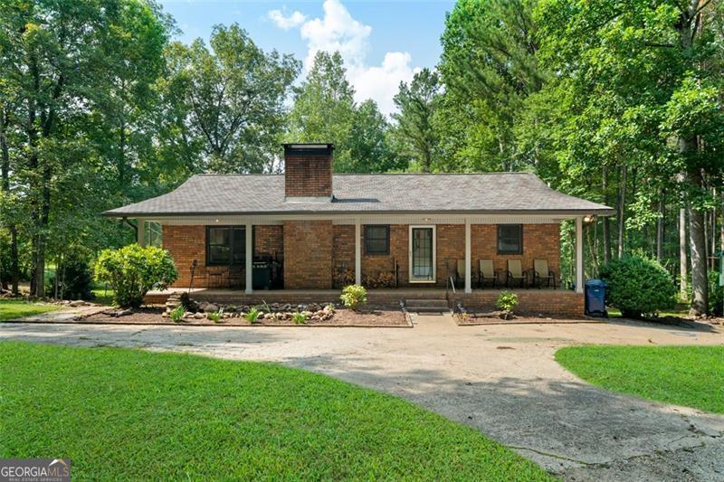 Nestled on 3 serene acres in the heart of Winston, this beautiful 4-bedroom, 3-bathroom home offers the perfect blend of privacy and convenience. From the welcoming front porch overlooking a charming koi pond to the wooded surroundings that provide peace and seclusion, this property is a true retreat. Inside, the freshly painted interior highlights stunning wooden beams in both the living room and primary suite, where you'll also find a relaxing soaking tub and dual vanities. The updated fireplace creates a warm focal point, while the newly added third bathroom in the basement adds comfort and functionality. With plenty of room for entertaining or quiet evenings at home, this residence balances modern updates with natural charm. Located just minutes from town and offering quick access to major highways and I-20, you'll enjoy the ease of commuting while still feeling tucked away in your own private oasis.