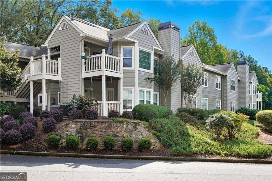 Chic, Convenient Condo Living Just Minutes from Downtown Roswell ~  Fall in love with the easy lifestyle in this beautifully updated 2-bed, 2-bath home ideally located just minutes from the heart of Downtown Roswell. This inviting condo features a desirable split-bedroom floor plan, luxury vinyl plank flooring, new windows and recent interior paint.  Enjoy cozy evenings by the fireplace in the spacious family room, and cook with ease in the open-concept kitchen complete with stainless steel appliances. The primary suite offers a generous walk-in closet and a peaceful retreat from the day. Step outside to your private deck, perfect for morning coffee or unwinding at sunset, all overlooking serene, wooded views.  Nestled in a quiet, low-traffic community, this home offers the perfect balance of tranquility and convenience-with top-rated dining, shopping, and entertainment just moments away. Community Perks: Hidden Lake is a private, amenity-rich community featuring a swimming pool, scenic walking trails, and a tranquil lake for residents to enjoy.