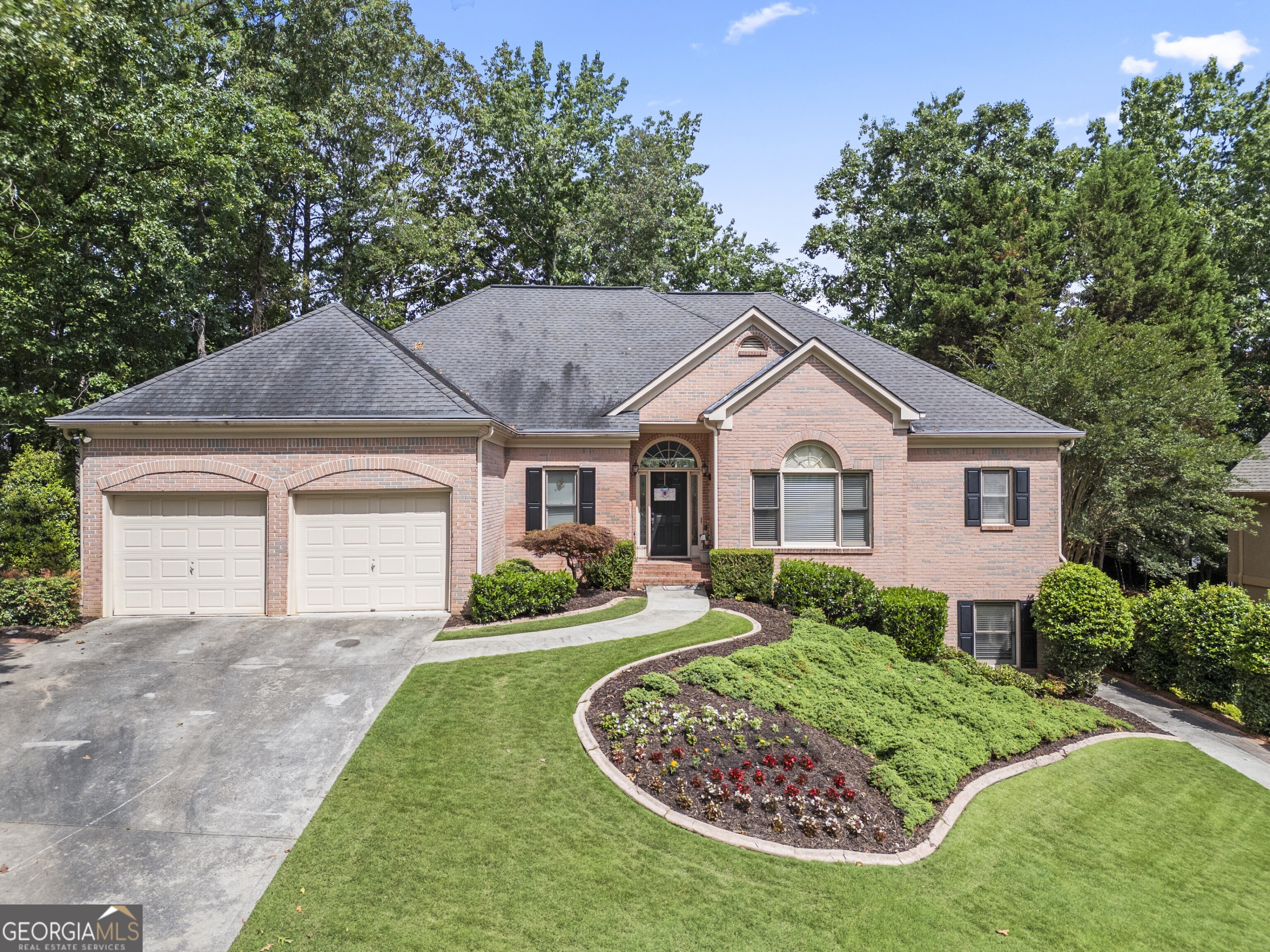 Welcome to this beautifully designed 6-bedroom, 4.5-bath home located in the desirable Fairways neighborhood in Towne Lake. With its versatile layout and full finished basement, this home is ideal for multi-generational living, in-law suites, or extended guests. The primary living spaces are conveniently situated on the main floor, including the generous primary suite with an oversized closet and en-suite bath, along with two additional bedrooms connected by a Jack-and-Jill bathroom. You'll also find two linen closets for extra storage on this side of the home. The bright, welcoming foyer opens to a formal living room with a large picture window overlooking the freshly resurfaced deck and private, landscaped backyard. The heart of the home centers around the open kitchen, complete with a breakfast room, breakfast bar, kitchen island, walk-in pantry, stained cabinets, and granite countertops-all with a view to the inviting family room. Anchoring the family room is a cozy fireplace flanked by custom built-in bookcases. French doors lead from the family room to the expansive deck, perfect for outdoor entertaining. Tucked away off the main living area is a powder room and a large laundry room for added convenience. Upstairs, you'll find a private bedroom with a full bath and walk-in storage, offering a perfect guest suite, teen retreat, or home office. Downstairs, the full finished basement-with exterior entry-features a complete apartment setup, ideal for in-laws or guests, plus a dedicated shop area perfect for hobbies, crafts, or extra storage. The basement mirrors the footprint of the main level, offering tremendous flexibility for a variety of uses. With thoughtful design, flexible living spaces, and a prime location in one of Towne Lake's most desirable neighborhoods, this home is ready to welcome its next owner. Don't miss your chance to make it yours-schedule your private tour today!