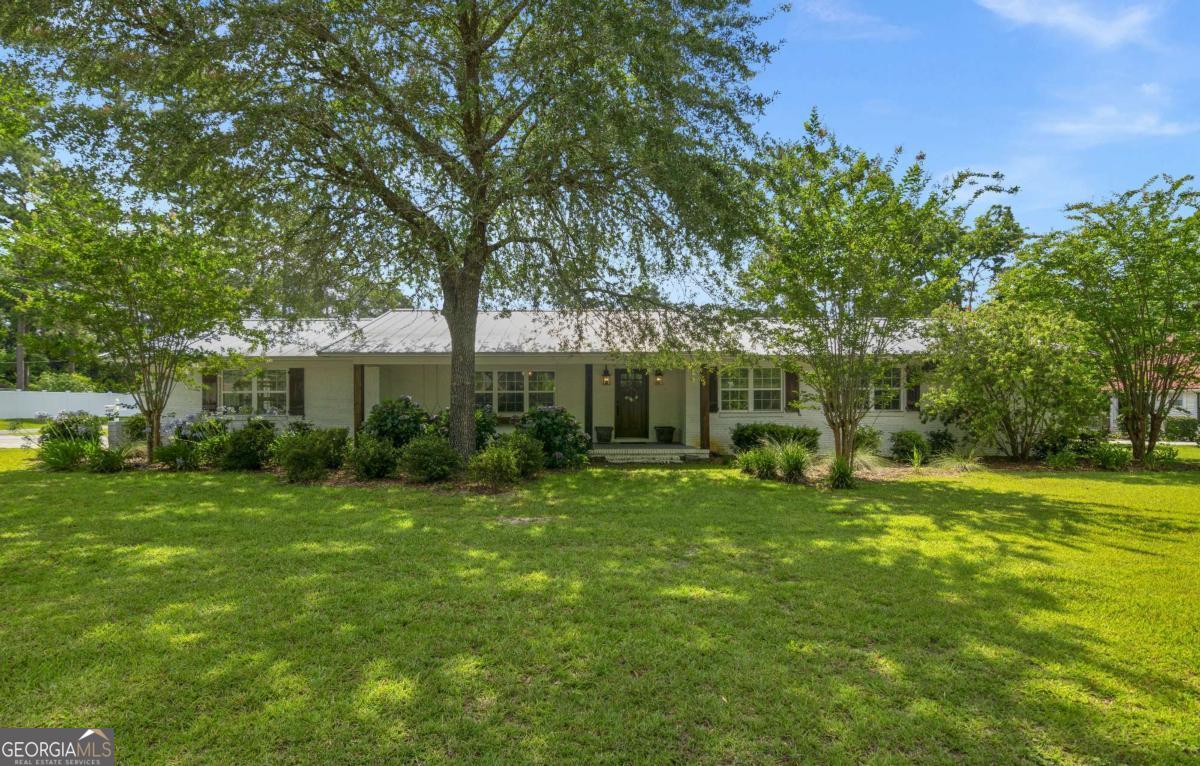 Welcome to this beautifully updated home nestled in the heart of Blackshear, GA! This spacious 4-bedroom, 4-bathroom residence offers the perfect blend of comfort, charm, and functionality. Step inside to discover a warm and inviting open layout, featuring a large flex space right off from the kitchen and dining room which is perfect for a playroom, gym, or second living area. There is also a separate dedicated office space, ideal for working from home. The spacious open layout of this home is complemented by natural light and thoughtful finishes throughout. The spacious primary suite is sure to impress with ample closet storage and a large ensuite bathroom with a nice soaker tub and separate shower. Outside, the charming exterior is enhanced by gorgeous landscaping that adds curb appeal and creates a tranquil setting. For hobbyists or those in need of extra storage, the property includes a separate workshop/storage building and a covered RV shelter-a rare and valuable addition. Located close to schools, shopping, and all that Blackshear has to offer, this home is a must-see! Don't wait, you could be sitting on the front porch and enjoying the views of your new yard soon.