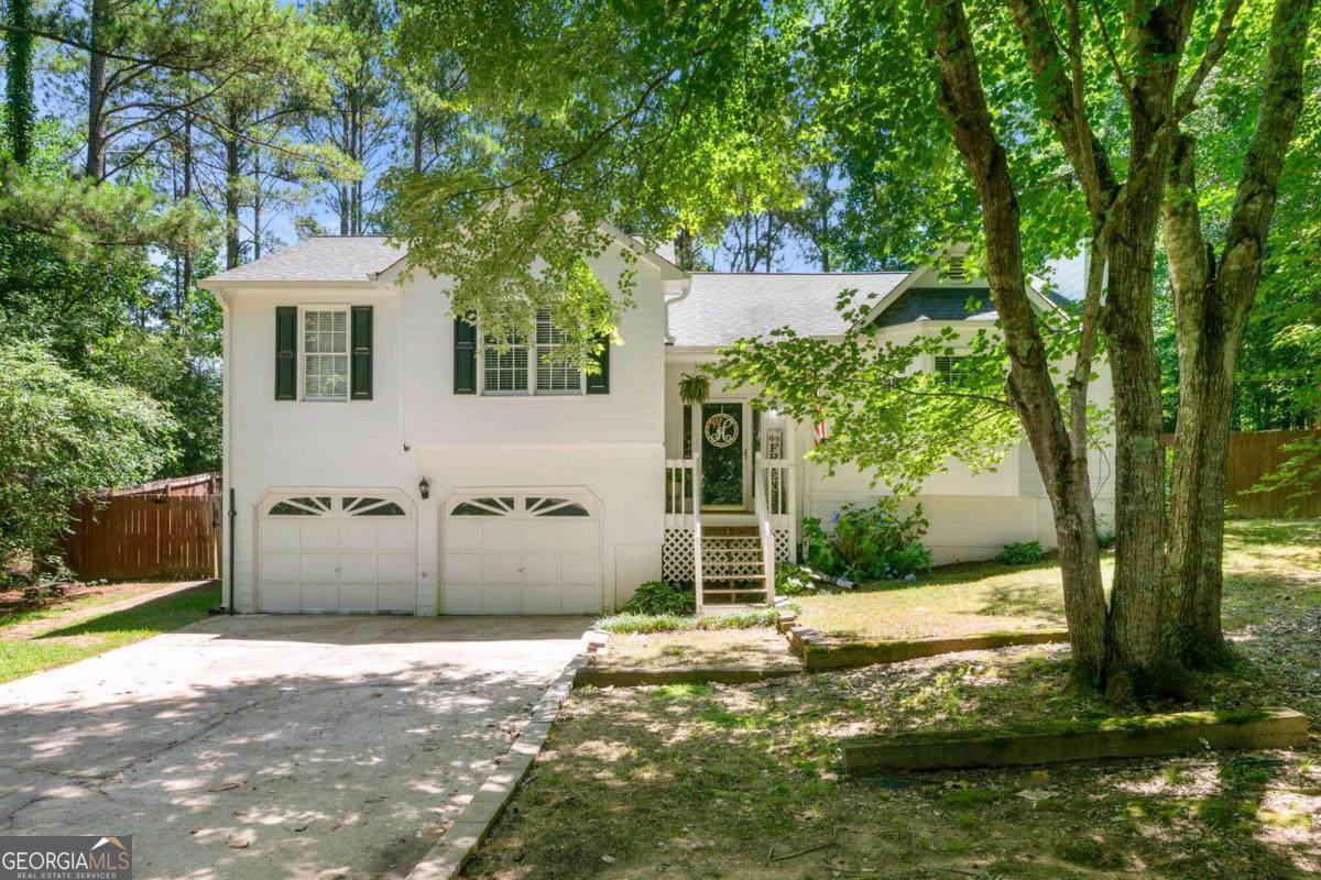 Look no further, You will love this 3 Bedroom, 2 Bath home on a private .58 Acre lot in East Paulding! Newer major systems! New Interior Paint! No HOA! Large open living space includes a spacious family room with fireplace, an open Kitchen and Dining area. Hardwood floors flow throughout the home. The interior has been repainted to a neutral white color. The Master includes a tray ceiling, a master bath with double vanity, separate shower and tub. Two more well sized bedrooms make up the main floor and share a remodeled full bath with tiled floor and a tub/shower combo. Head downstairs to the unfinished basement just waiting for you to finish it with your unique touches. Perfect for an office, playroom, teen suite or extra storage. Step outside onto a new back deck to view a fenced-in paradise that displays apple and cherry trees, lady banks and roses. You will enjoy the firepit area on those cool fall nights. Located in a desirable area, this home is conveniently close to schools, shopping, and dining. Don't miss out on this fantastic opportunity to make this house your new home!