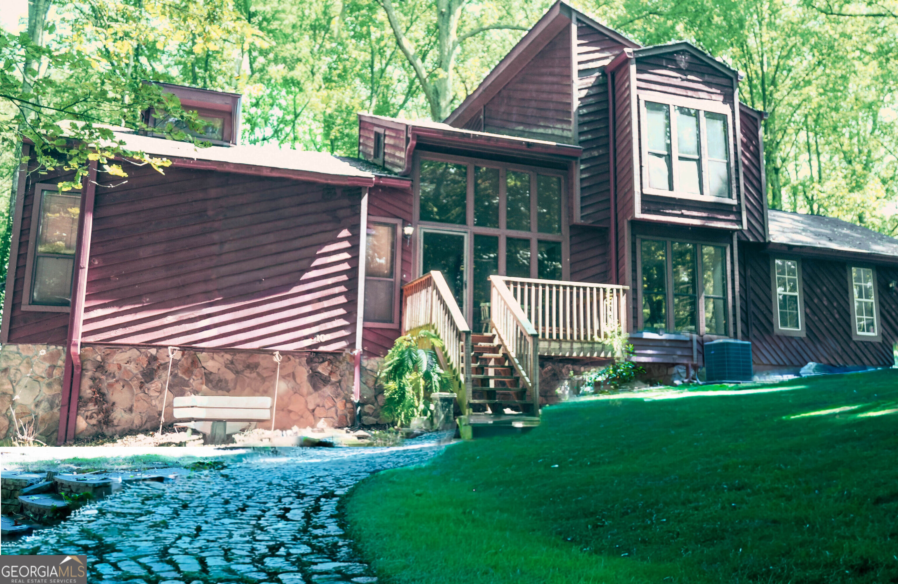 Welcome to this striking contemporary home, tucked away in a private wooded setting, with two driveways! Endless possibilities await on this 1.67-acre property in Snellville! This 3BR/2.5BA split-level home features. The home's exterior showcases contemporary architecture with cedar-style siding, stone accents, and dramatic rooflines, creating a chalet-inspired feel. Step inside to discover soaring ceilings, sun-drenched rooms, and expansive views of the surrounding forest. 2050 sq ft of living space plus including an unfinished basement, offering plenty of room to grow. The primary suite is conveniently located on the main level, and the home is filled with natural light throughout its expansive glass pane windows. With no HOA, you'll have the freedom to expand, garden, or design the outdoor living space you've always wanted. Whether you're an investor seeking a great opportunity or a buyer ready to personalize your luxury dream home, this property offers the perfect canvas. Property is being sold AS-IS and there are no disclosures.