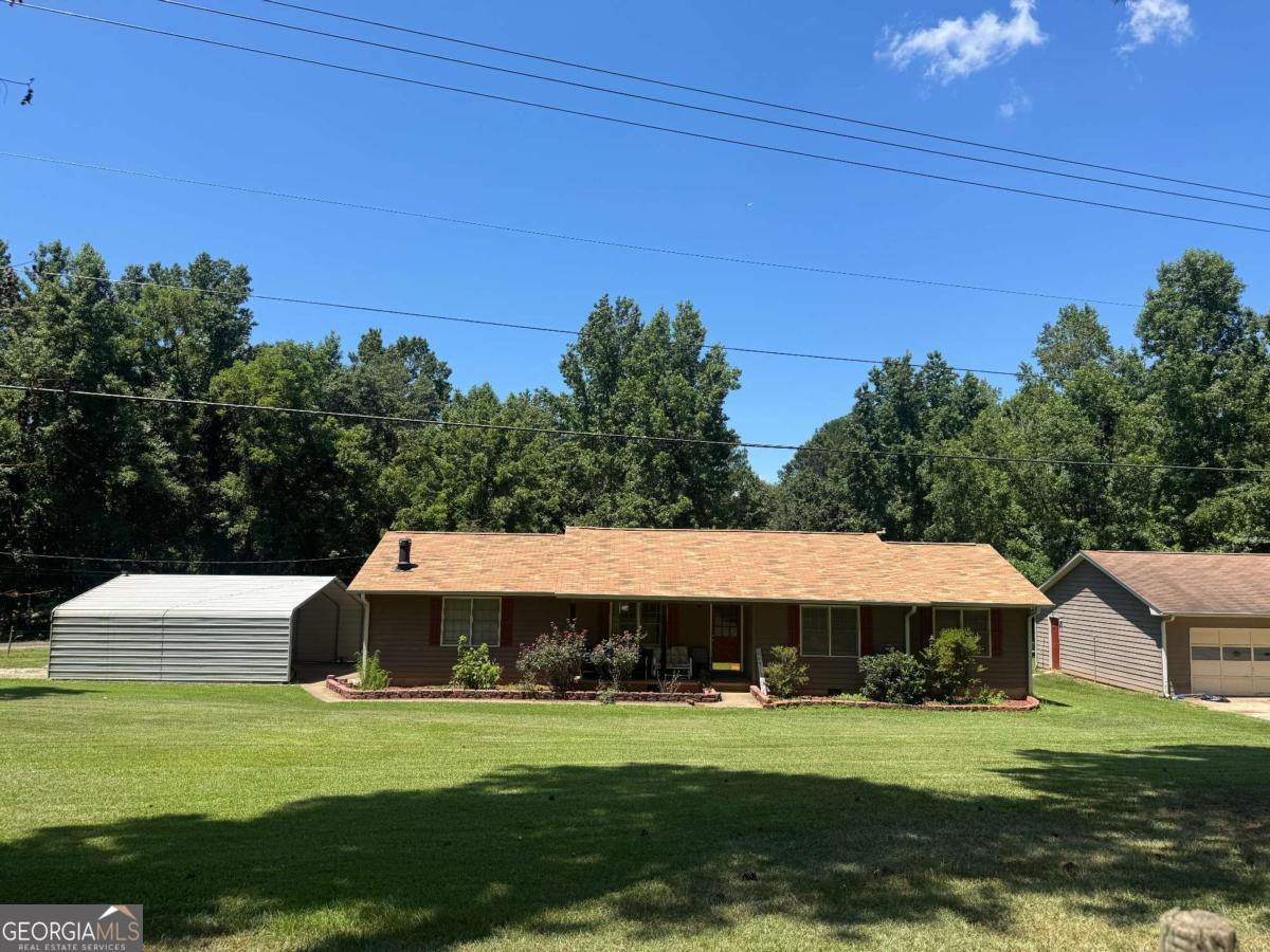 This fenced corner lot boasts 2.8 acres of land!!!! 2 parcels included in this sale. This is a well maintained owner property ready for a quick move in. This home has 3 bedrooms, 2 baths and it includes a detached garage workshop area perfect for anyone who appreciates woodworking. The workshop is equipped with 220V, equipment shed and metal carport. New roof and new carpet/flooring throughout. This home is perfect for entertaining outdoor gatherings. This property is a short distance to 1-285, I-85, Atlanta's Hartsfield-Jackson Airport, shopping, and restaurants. This property is also near great outdoor green spaces, like the beautiful Cochran Mill Park.