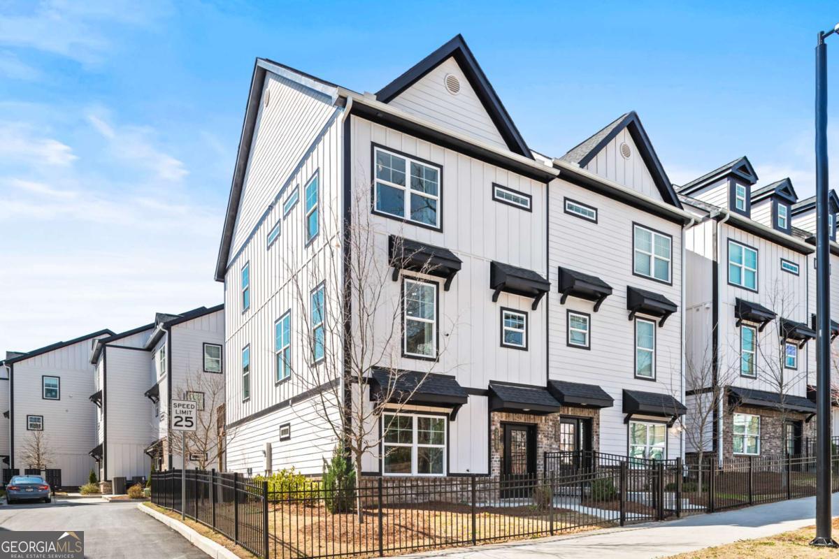 Nestled in the Riverside neighborhood of West Midtown Atlanta, this stunning 3-level end unit townhome is a park lover's dream. Featuring 3 bedrooms and 3.5 baths, the spacious chef's kitchen boasts Whirlpool energy-efficient stainless steel appliances, quartz countertops, and a walk-in pantry-perfect for culinary enthusiasts. The open-concept second floor seamlessly connects the kitchen, dining, and living areas, with a convenient half bath for guests. The third level is home to an oversized primary suite with a walk-in closet and double vanity sinks, plus a second bedroom with a private bath. A laundry room is thoughtfully located between the two bedrooms on the third floor. The lower level offers versatile space with a full bath, ideal for a home office, bedroom, media room, or hobby space. Spink-Collins Park, with its lush green spaces, trails, and recreational facilities, is just moments away. Enjoy the convenience of nearby Westside Park, Chattahoochee Foodworks, and an array of restaurants, coffee shops, and bars. Publix, yoga studios, and more are just a 7-minute drive. Live in style and comfort in one of Atlanta's most sought-after neighborhoods!