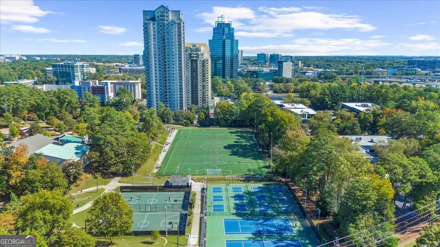 Experience the ultimate in convenience and comfort with this beautifully updated 6th-floor studio condo, perfectly positioned in the heart of Sandy Springs-right at I-285 and GA-400. Enjoy sweeping views of Hammond Park's 13+ acres of green space, complete with basketball courts, tennis courts, playgrounds, sports fields, and more-all just steps from your door. Inside, the condo features engineered hardwood and tile floors, an updated kitchen with natural wood cabinetry and stainless steel appliances, and a bright alcove area ideal for a home office or reading nook. The bathroom offers a clean, modern look with a white vanity and tiled tub/shower combo.  This condo is perfect for anyone seeking a low-maintenance lifestyle or a central Atlanta home away from home. The community provides exceptional amenities including a 24-hour front desk, on-site convenience store, fitness center, pool, and dog park.  A rare bonus - this studio includes two parking spaces and two storage cages, with the option to rent or sell the second parking space for extra income.  Live, work, and play in the center of it all-Sandy Springs living at its finest!