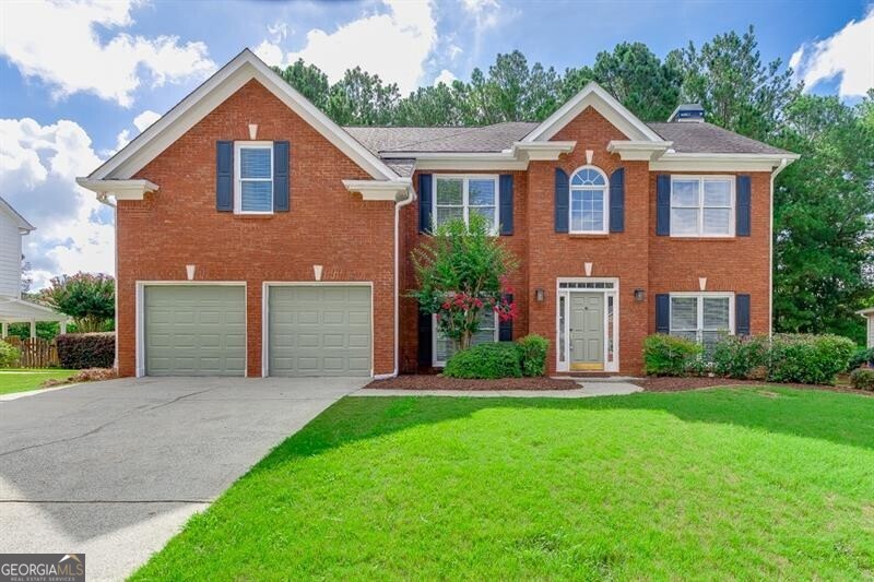 This move-in ready 2-story brick-front home is located in the highly sought-after Hamilton Mill community with resort-style amenities and the Mill Creek school cluster. The main level welcomes you with fresh updates including NEW interior and exterior paint, REFINISHED hardwood floors. You'll find a separate formal dining and family room, along with a cozy living room featuring a fireplace, wood-paneled accent wall, and ceiling fan. The kitchen has been beautifully updated with stainless steel appliances, including a NEW gas stove, NEW microwave, dishwasher, and refrigerator. An oversized pantry, breakfast area, and built-in mail center make the space as functional as it is inviting. A laundry room and guest bath complete the first floor. Upstairs, the main suite features a relaxing retreat with a double tray ceiling, wood-paneled accent wall, upgraded lighting, a spacious walk-in closet, and a spa-like bathroom with double vanity, separate tub and shower, and linen closet. You'll also love the 3 additional spacious bedrooms and 2 FULL baths that provide plenty of room for family or guests. The backyard is fully fenced, freshly landscaped with new sod, and features a deck-perfect for relaxing evenings or weekend gatherings. LAWN CARE IS INLCUDED for added convenience. You'll enjoy Hamilton Mill's incredible amenities, including eight tennis courts, a basketball court, beach volleyball, playground, resort-style pool, and kids' pool. Conveniently located off I-85 (Exit 120) and Braselton Hwy, the home is just minutes from schools, Publix, Walmart, Chick-fil-A, Home Depot, Kohl's, movie theaters, churches, parks, and so much more. ***We DO NOT list rentals on Craigslist nor Market place. Only communicate with The Gwin Team, beware of rental scams - this house is professionally listed by The Gwin Team, ONLY speak with a member of The Gwin Team***