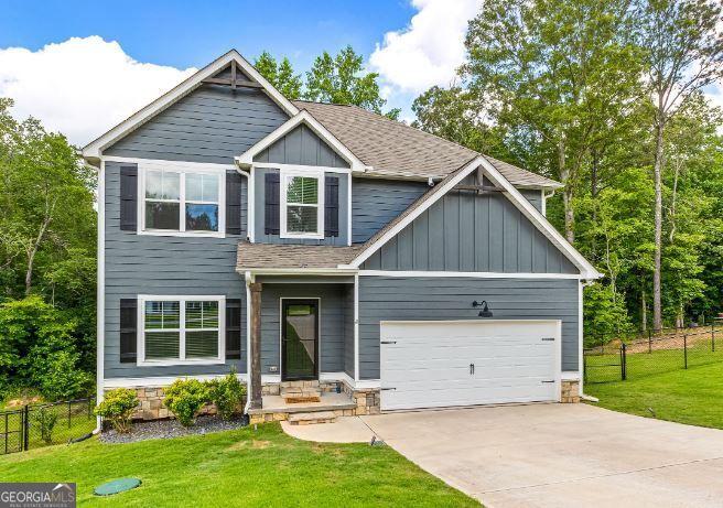 Welcome to your next dream home in The Ridge at Armstrong Crest-one of Carroll County's most desirable neighborhoods! This nearly new home blends timeless charm with modern convenience and offers room to grow with an expansive unfinished basement already stubbed for a full bath-ready for your personal touch. Step inside to warm wood flooring throughout the main level's living areas, creating a seamless flow and cozy ambiance. A flex space on the main floor offers endless possibilities-perfect for a home office, playroom, guest space, or even a fifth bedroom. The kitchen is a showstopper, featuring a stylish mix of white and farmhouse blue cabinetry, gleaming quartz countertops, stainless steel appliances, and an open view into the family room-ideal for entertaining or everyday family life. The adjacent dining room makes a statement with its custom ceiling design and bold feature wall, creating a perfect setting for special occasions. Upstairs, the owner's suite is a true retreat with a tiled walk-in shower and soaking tub to unwind in style. Fresh interior paint and new carpet add a clean, move-in ready feel throughout the home. Three additional bedrooms and a full bathroom are also found upstairs. The fenced backyard offers privacy and tranquility with mature trees lining the rear and newly installed French drains for added peace of mind. Conveniently located near I-20 and just minutes to downtown Carrollton, this home offers easy access to schools, parks, shopping, and dining. Don't miss this opportunity to own a beautifully maintained home with room to grow in a community you'll love.