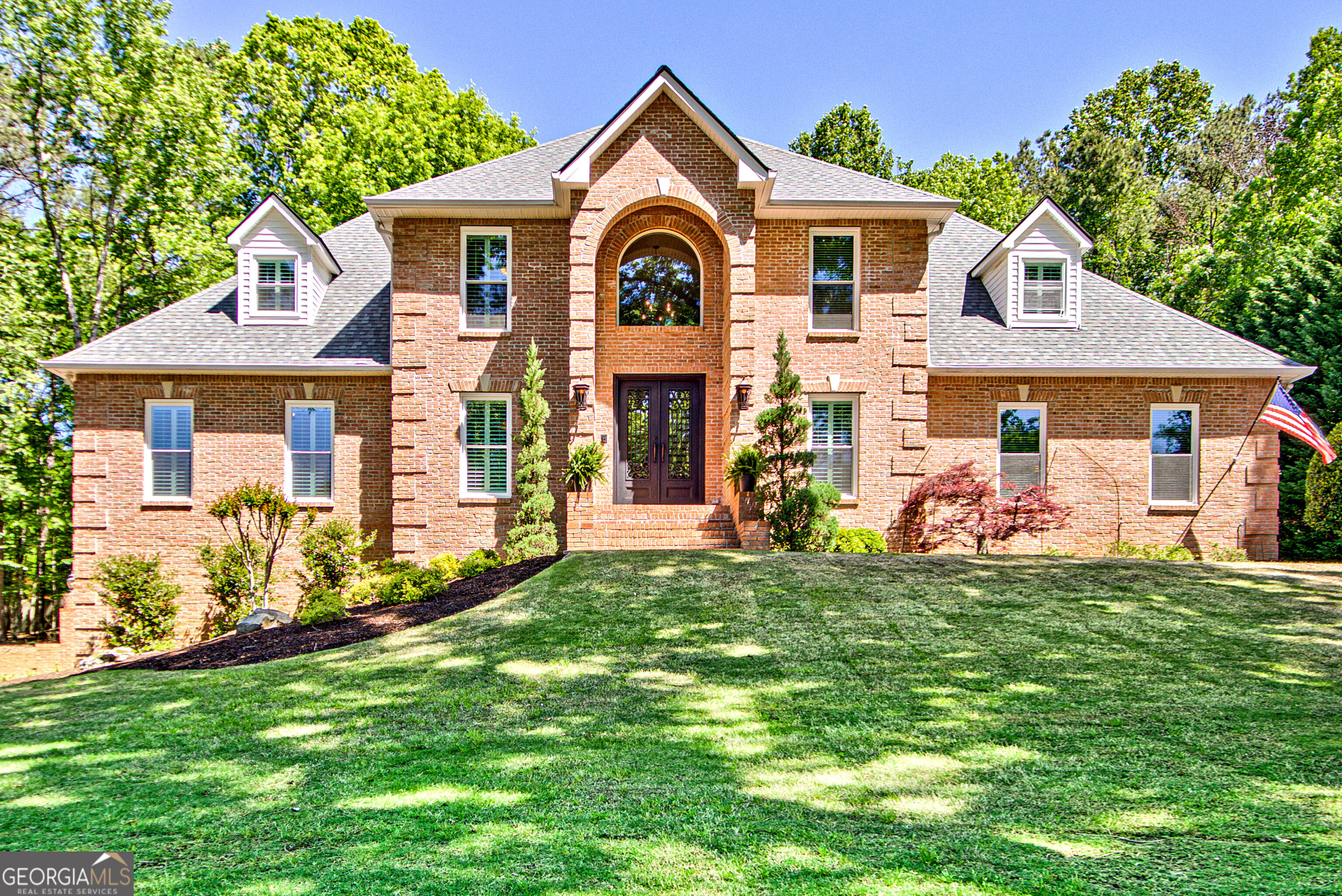 Immaculate 4-sided brick dream home with swimming pool in Smokerise Estates. Original owner's care shines through, plus endless upgrades at every turn.  Zoysia lawn and pristine landscape offer grande curb appeal. Double iron doors welcome you into the foyer, revealing a full main-level renovation. Formal living with french doors and dining room with wood detail flank the entryway. Designer kitchen with JennAir appliances, soft-close cabinetry, induction cooktop, and  stunning Taj Mahal Quartzite countertops make the space as beautiful as it is functional. Breakfast bar with pendant lighting. Breakfast nook steps out to vaulted sunroom overlooking pool. Adjacent living room with upgraded fireplace and arched windows leads to office with french doors.  Gracious primary suite on main with tray ceiling and sliding door to renovated bath retreat, which includes heated floors with wireless controls, frameless open shower with rain head, and second shower head plus spray wand, double vanity, new cabinets with soft-close drawers.  Custom built-in cabinetry and shelving in expansive primary closet. Also on renovated main level, a mud/laundry room with 'friends entrance', cabinetry, designer tile and laundry sink.  Full bath with shower for pool guests.     Trex decking leads from the first floor outside to fenced oasis. Inground pool has new, upgraded 'sea glass' liner. Soft, anti-slip pool surround provides comfort and safety.  Tranquil backyard retreat is the perfect place to relax with mature trees, immaculate landscaping and side yard with grass for play.      Back inside, four spacious and unique secondary bedrooms are upstairs. One ensuite, with built-in desk and nook.  Jack-and-Jill bath splits bedrooms two and three, one being a large teen suite with sitting room and built-in desk.  A fourth upstairs room is an ideal office, craft space or nursery. Ample walkout attic storage.      The terrace level offers areas for entertainment, plus bed and full bath. Newer carpet and fresh paint. Terrace level garage with slat wall and more storage for lawn equipment or tools. Andersen french doors walk out to side yard.    Spotless 3-car garage is a car-enthusiast's or craftsman's dream!  Epoxy floor coating, work table, slat wall organizer, upgraded cabinetry and programmable door remotes.     Home upgrades include new Pella windows, new TRANE HVAC units, new 50-year roof, louvered shutters, fresh paint, whole-house vacuum, additional soundproofing insulation, septic serviced, plentiful storage throughout.    Located in the highly-desired Smokerise Estates, enveloped in trees and nature, yet minutes away from everything. Located on 100+ miles of golf cart paths, golf cart to  fabulous restaurants, shopping and grocery stores.  Located in north Peachtree City, you are ideally located with easy access to Atlanta Hartsfield and Trilith Studios. This custom home is truly a 10/10!