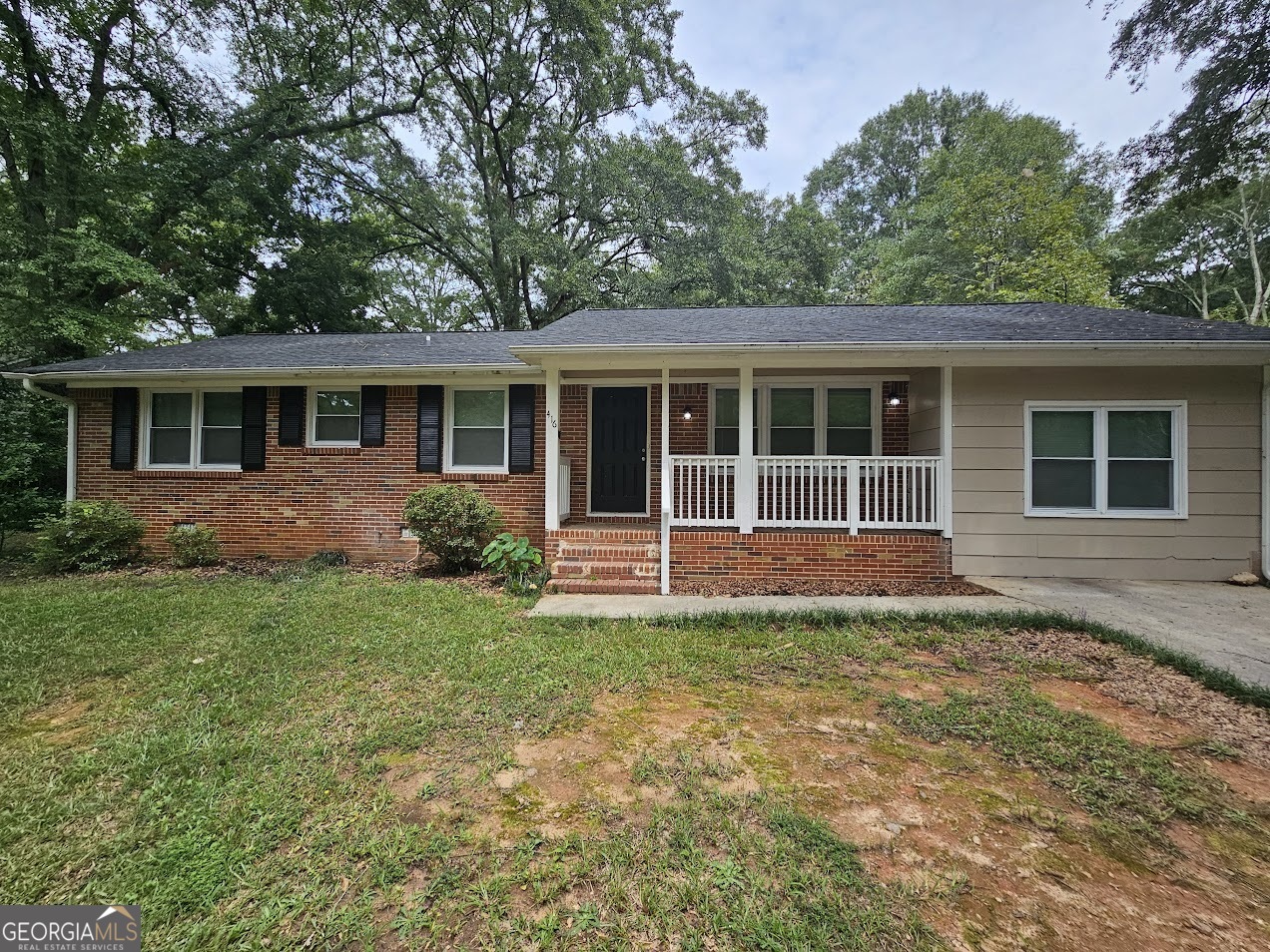 Introducing a spacious 4-bedroom, 2-bath brick ranch nestled on a generous 1-acre lot in Monroe's historic Walton County seat. Built in 1964, this single-story gem offers a blend of carpet and hardwood floors, a cozy fireplace, and classic composition roof with masonry foundation. The welcoming layout includes ample living space, a functional kitchen, and a two-car garage for convenience. Outside, the wooded yard ensures privacy and abundant outdoor potential. Conveniently located just minutes from Monroe's charming downtown square, residents enjoy easy access to local shops, dining, and the vibrant antique markets now housed in repurposed cotton mills. Plus, it's roughly an hour from Atlanta, offering both small-town ease and big-city accessibility. This property is ideal for families or anyone seeking peaceful suburban living with classic charm and rural space.