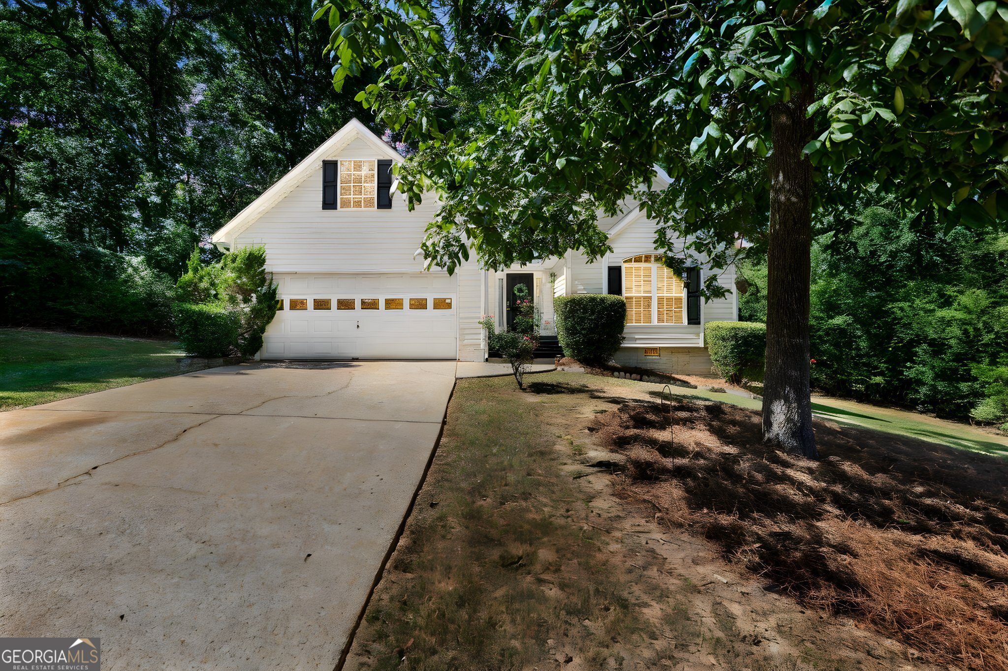 Welcome to this charming Sharpsburg ranch tucked away on a quiet cul-de-sac with a level lot and a beautiful magnolia tree in the front yard. Step inside to a tile foyer with coat closet and enjoy a spacious living room with vaulted ceilings and a cozy wood-burning fireplace, perfect for crisp fall evenings. The bright, white eat-in kitchen shines with quartz countertops, stainless steel appliances (all remaining), and updated plumbing and light fixtures throughout, while hardwood floors flow through the common areas and soft carpet keeps the bedrooms cozy. The primary suite offers trey ceiling, a walk-in closet, standing shower, and garden tub and an inset medicine cabinet-just like the good ol' days. Outside, a fenced backyard w/ deck invite you to sip your morning coffee and watch the autumn leaves fall. Updates include fresh paint, a new attic staircase (2025), all-new ceiling fans with remotes, blinds throughout, and two TV mounts that stay make this home truly move-in ready. With a 2-car attached garage with shelving and all-electric utilities, this home blends modern updates with timeless comfort-call your agent today to schedule a showing