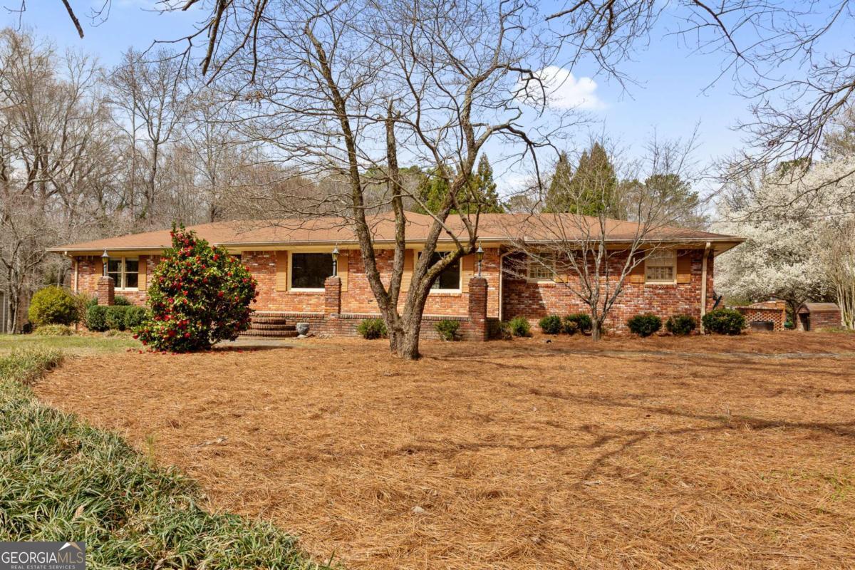 Perfect opportunity to own nearly one acre in the highly sought-after East Cobb area within the prestigious Walton School District. Tear down and build or discover the endless possibilities with the existing charming brick single-family home. Whether you're looking for a primary residence, an investment opportunity, or the perfect lot to build your dream home, this property offers it all. The home features four bedrooms and three bathrooms, providing ample space for family living, guests, or flexible room configurations. The heart of the home features spacious living and dining areas, ideal for entertaining or relaxing. The kitchen offers ample counter space and cabinetry, providing plenty of room for preparing meals or hosting guests. The partially finished walk-out basement adds even more potential. It includes a private bedroom and bathroom, making it the perfect retreat for guests, in-laws, or as a potential source of rental income. The unfinished portion of the basement offers endless possibilities to suit your needs, whether for a home gym, workshop, or additional storage space. Set on a spacious .8-acre lot, the home boasts a large backyard and three patios, ideal for outdoor relaxation, playtime or entertaining. The sparkling working pool, complete with a custom-built filter house, new liner, an energy-efficient solar cover, and a custom brick lattice fence provides a private relaxing oasis. Conveniently located with easy access to Roswell Road and I-75, this home is close to a rich selection of shopping, dining, and entertainment options. Nature enthusiasts will appreciate the nearby parks, trails, and natural areas, making it easy to enjoy outdoor activities year-round. This versatile property combines comfort, convenience, and opportunity in a prime location. Don't miss out on the chance to make this exceptional home your own - schedule your private tour today!