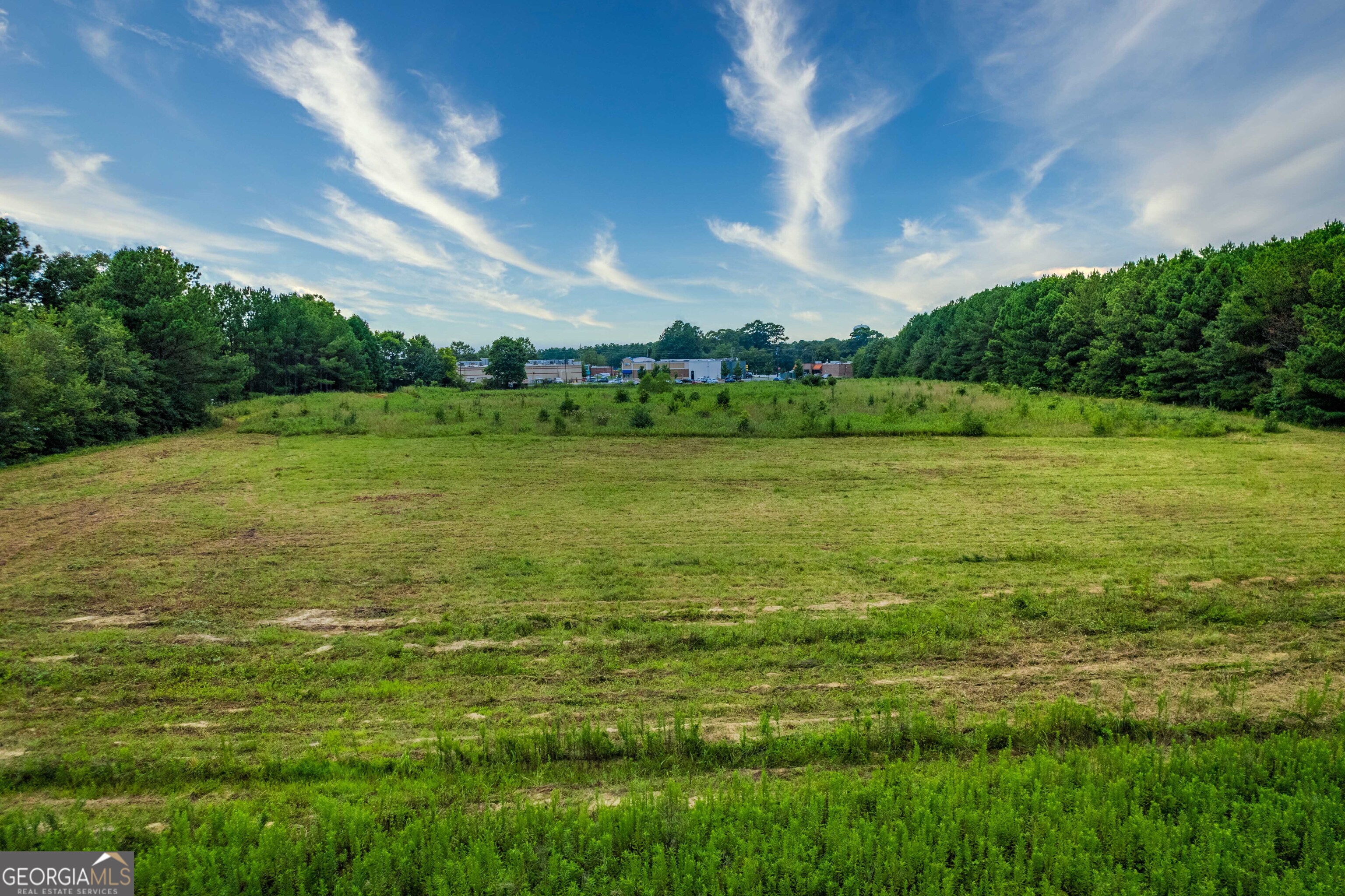 Additonal 1 acre with retention pond available deed book 12253, page 262. Parcel: 5160281 (4116 Atlanta Hwy) (Trc1 pecan Rd) This conveniently already cleared commercial property with CH zoning is the perfect location for 78 access without the immediate 78 traffic. Access to the property through Pecan street with an additional acre available totaling to 6.84 acres. conveniently lining the back side of many businesses and eateries, as well as walking distance to downtown loganville.