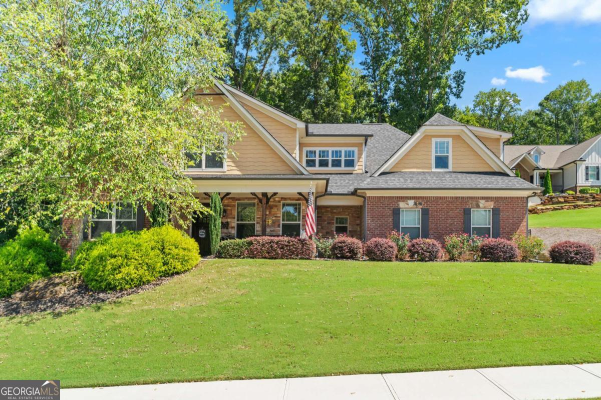 Welcome home to this stunning 5 bedroom, 3 bathroom residence in the highly desirable, gated Scenic Falls neighborhood. Featuring an ideal layout with the primary suite on the main level, this home offers both convenience and comfort. Step inside to find an open-concept kitchen with white cabinetry, stainless steel appliances, and a large center island, perfect for meal prep or casual dining. The kitchen flows seamlessly into the cozy living area and sunny eat-in space, creating the perfect setting for gatherings. A unique built-in nook under the stairs, complete with a secure gate, provides the perfect spot for your furry friends. The main-level owner's suite features a spacious walk-in closet, a soaking tub, and a tiled walk-in shower with bench seating. An additional bedroom and full bathroom are also located on the main floor. Upstairs, you'll find two more bedrooms, a full bath, and a generous bonus room that can be used as a fifth bedroom, home office, or playroom. Step outside to enjoy a private screened-in porch overlooking the beautifully landscaped yard. The backyard offers a true retreat with a large fenced lawn, sitting area, and plenty of space for outdoor entertaining or quiet relaxation. Scenic Falls residents enjoy exceptional amenities including a clubhouse, swimming pool, and tennis courts. Conveniently located just minutes from I-85, this home offers both a peaceful retreat and easy access to shopping, dining, and commuting.