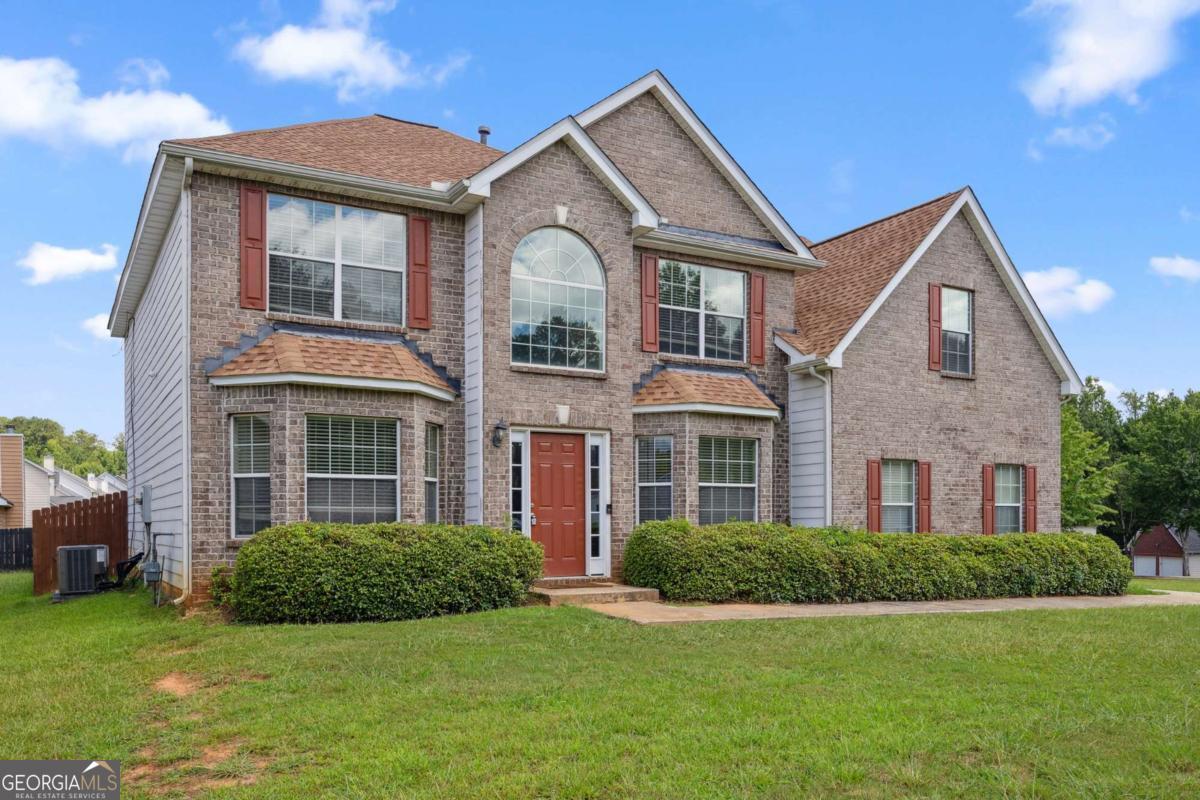 Traditional charm meets opportunity in this classic brick home situated in a prime, highly convenient location. Being sold AS-IS, this property offers incredible potential to refresh and personalize with just a little TLC. New roof in 2021 and new HVAC in 2024. A welcoming front stoop leads into a grand two-story foyer highlighted by a large palladium window that fills the space with natural light. The main level features stylish LVP flooring and elegant wainscoting, with both a formal living room and an adjoining formal dining room, perfect for entertaining. A versatile main-level bedroom and full bathroom offer flexibility for guests, a playroom, home office, or more. At the heart of the home is a spacious, open-concept kitchen and family room complete with a cozy wood-burning fireplace, stainless steel appliances, ample counter space, and room to add an island for additional prep, dining, and serving space. Upstairs, retreat to an oversized vaulted primary suite featuring a double vanity with a makeup counter, soaking tub, walk-in shower, and a generous walk-in closet. All secondary bedrooms include beautiful double tray ceilings, and an additional full bath provides comfort and convenience. Enjoy outdoor living in the fully fenced private backyard with a patio area perfect for relaxing or dining under the stars. Conveniently located near schools, healthcare, major highways for a smooth commute, and plenty of shopping, dining, and entertainment. This is a fantastic opportunity to invest in a well-located home with classic character-sold AS-IS and ready for its next chapter.