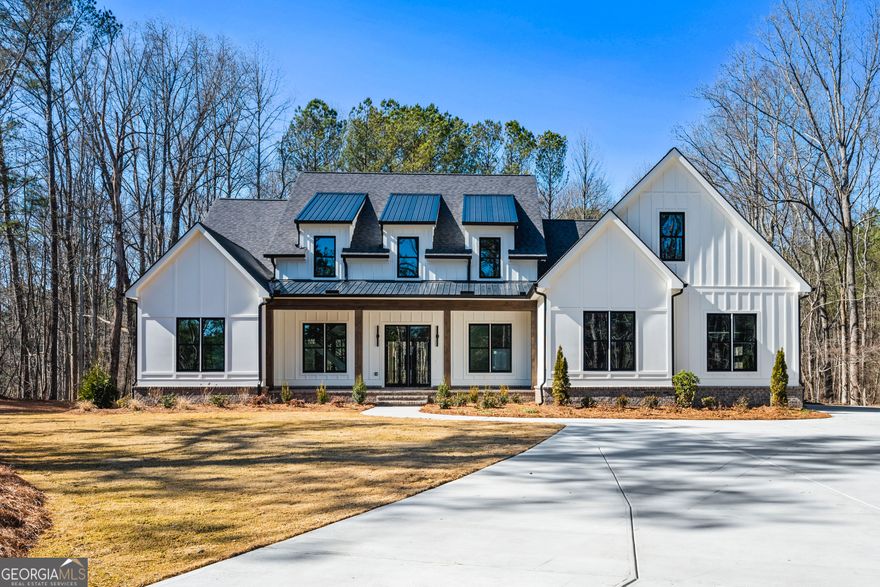 A STEAL OF A DEAL! Reduced $250! Experience modern luxury and timeless charm in this brand-new custom-built Modern Farmhouse by TrueRidge Homes, situated on 1.56 private acres in the highly desirable Alpharetta/Milton area. Conveniently located just minutes from top-rated schools, shopping, and dining, this stunning property also benefits from low Cherokee County taxes. Move-in ready by late-January 2025, this home is the perfect place to start the new year in style. The main level is thoughtfully designed to blend elegance and functionality. Step through the elegant glass front door into a spacious foyer that opens to an open-air staircase with sleek metal railings. The layout features a luxurious master suite, a guest bedroom with an en-suite bath, and a private office adorned with designer metal-and-glass barn doors. The heart of the home is the chef's kitchen, complete with floor-to-ceiling white cabinetry, soft-close drawers, quartz countertops, and a stylish tile backsplash. The massive center island with a prep sink is perfect for entertaining, while premium Thermador appliances-including a 6-burner gas range with a grill, double oven, professional vent hood, built-in refrigerator/freezer, microwave, and beverage center-elevate the culinary experience. A spacious walk-in pantry provides ample storage. The kitchen flows seamlessly into a beamed, fireside family room, which opens to a covered outdoor deck featuring its own fireplace. The main level also includes a well-appointed laundry room with cabinetry, marble counters, a utility sink, and a custom mudroom drop zone. Upstairs, hardwood floors run throughout, leading to a loft area ideal for relaxation or play. This level offers one bedroom with a private en-suite bath, two additional bedrooms with a shared Jack & Jill bath, and a generously sized bonus room ready to suit any need. The expansive daylight terrace level remains unfinished, offering endless customization possibilities for a home theater, gym, or additional living space. Additional features include an oversized three-car side-entry garage, designer lighting throughout, tankless water heater, three HVAC systems for maximum efficiency, and aluminum-clad windows that enhance natural light and durability. Hardwood floors are featured on both the main and upper levels. Outside, the spacious backyard offers plenty of room for a pool and the freedom to enjoy life without the constraints of an HOA. This home is more than just a residence-it's a lifestyle. Impeccably designed and expertly crafted, it seamlessly combines modern elegance with practical living on a private, spacious lot. Schedule your private tour today and discover why this property is truly a perfect 10!