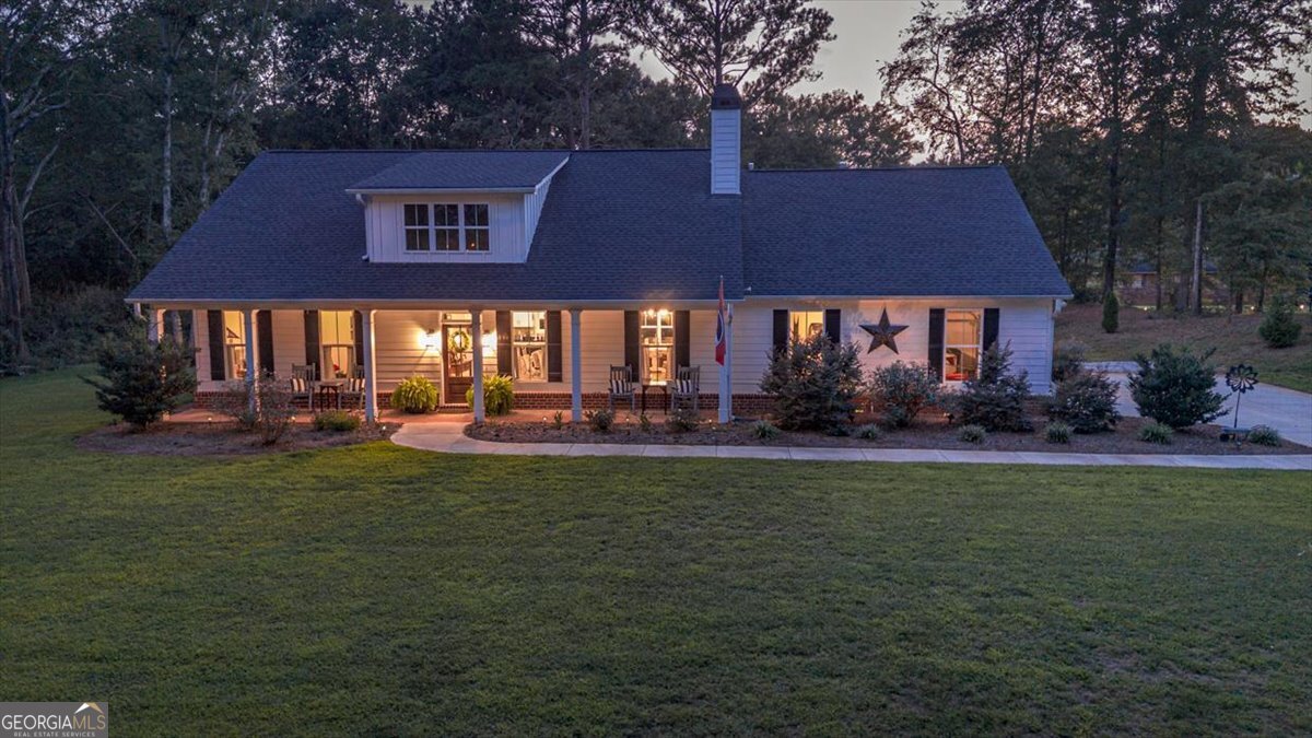 Charming Downtown Retreat: Your Dream Home Awaits! Discover the perfect blend of modern convenience and serene, private living in this stunning four-bedroom, 2.5-bath home, ideally situated in a golf cart-accessible area of downtown. Nestled on over an acre of lush landscaping and not in a subdivision, this property offers the space and tranquility you've been searching for. Step inside to an inviting open floor plan featuring soaring high ceilings that create a sense of spaciousness and light. Gas fireplace adding a cozy touch. The oversized dining room is perfect for large family gatherings and can comfortably accommodate an eight-person table, making it the ideal space for entertaining. The open kitchen boasts a gas stove and oven, gorgeous quartz island and a stylish new tile backsplash, seamlessly connecting to the living area for effortless flow. Natural light floods the home through large windows and doors, highlighting the beautiful real brick fireplace in the living room-a perfect spot for cozy evenings. The main living area features new luxury vinyl plank (LVP) flooring, providing durability and elegance. Each of the bedrooms is generously sized and carpeted, offering a warm and inviting retreat. The master suite is a true oasis, complete with a luxurious oversized tub adorned with a new tile backsplash-perfect for unwinding after a long day. Enjoy the great outdoors from your covered front and back porches, ideal for sipping morning coffee or evening sunsets. The expansive front porch is a delightful gathering spot, spacious enough for eight rocking chairs, inviting family and friends to relax and enjoy the views. The beautifully landscaped yard is fully sodded in the front and side, complemented by an irrigation system to keep your garden flourishing. You'll find majestic magnolia and oak trees throughout the property, along with fruit trees and a lovely rock garden in the backyard. A fenced-in area provides a safe haven for pets or a perfect spot for your own personal garden. This exceptional property combines the best of both worlds-peaceful living with downtown accessibility. Don't miss your chance to own this slice of paradise! Schedule a showing today and experience all that this wonderful home has to offer!