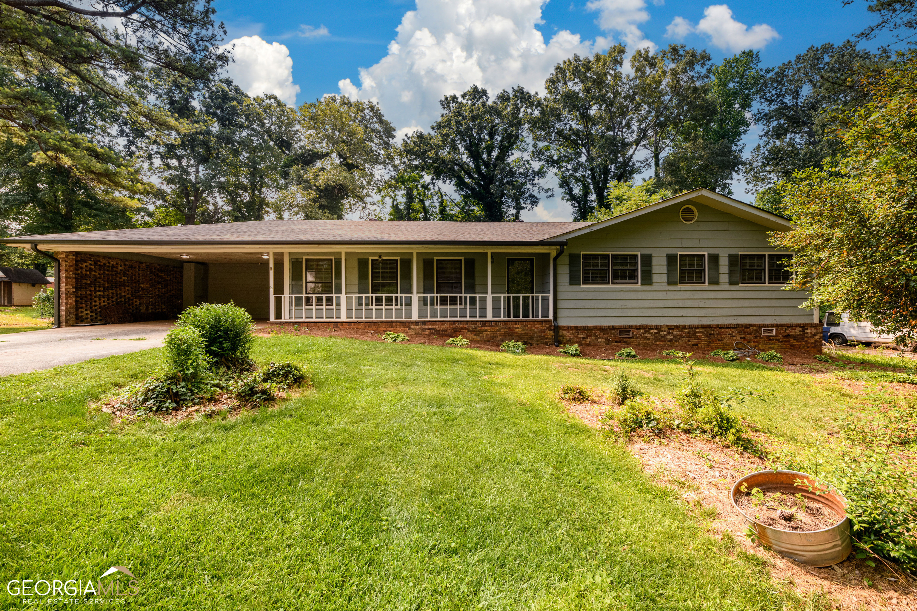 Check out this large Ranch with almost 1800 Sq feet in desirable Sugar Hill with NO HOA! This home features an eat-in kitchen, 2 large family rooms with fireplace and built in bookshelves! 3 bedrooms and 2 bathrooms. Large Laundry room and lots of cabinet space. Amazing screened in back porch to watch the game and relax. 2 car carport. New roof installed in June 2023 warranty. Aquaguard drainage system in Crawl space installed in 2021 and has a lifetime transferable warranty. Interior and Exterior paint done in 2019. New Heating Unit in 2019. New electrical panel in 2023. New lighting throughout, this home is mechanically updated and is just waiting for your personal touch! Close to DT Sugar Hill, Greenway, schools, and shopping! Hurry, this home won't last long!