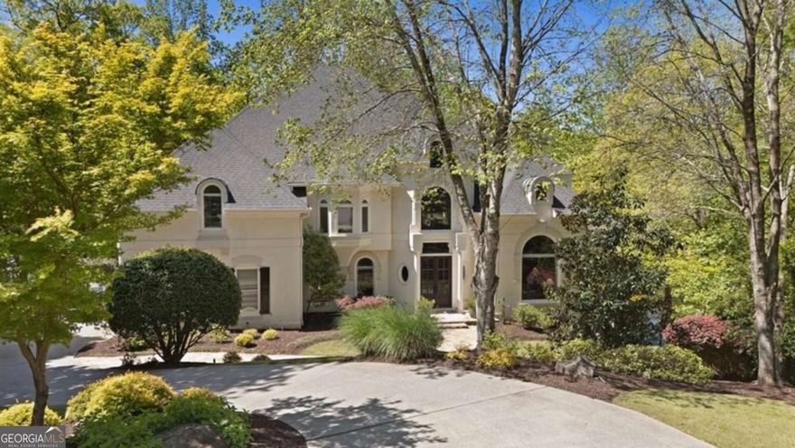 A One-of-a-Kind LAKEFRONT RETREAT, 960 Tiverton Lane in Johns Creek is Country Club of the South's best-kept secret!! Who knew serenity could look this good? Tucked away on what may be the most coveted lake lot and cul-de-sac setting in prestigious Country Club of the South, 960 Tiverton Lane is the hidden gem you've been waiting for. This custom estate artfully blends privacy, elegance, and modern upgrades-all perched above a tranquil lake, surrounded by lush trees and nature's soundtrack. Step inside to discover luxury at every turn, from designer lighting and custom window treatments throughout to an elegantly designed open-concept main level that invites you to gather, unwind, and soak in the view. The chef's kitchen is beautifully appointed with a new Wolf cooktop with automatic downdraft, SubZero refrigerator and flows seamlessly into the family room and casual dining area-all walking out to a scenic deck that feels like your own private treehouse. On the main level, the primary suite is a total transformation-featuring sweeping views of the tranquil setting. The thoughtfully reconfigured layout offers a sprawling custom closet with integrated lighting, lighted art niche, upgraded doors, and a refined spa bath. The home also offers a full working office with dramatic two-story vaulted ceiling-a rare and refined feature that elevates everyday living and work-from-home flexibility. Upstairs, you'll find four oversized ensuite bedrooms, each with updated baths, and rich hardwoods throughout the entire upper level. Downstairs, the expansive walk-out terrace level is ideal for multi-generational living and includes a full bedroom/exercise room, updated full bath, large recreational/media area, temperature-controlled wine cellar, and a complete second kitchen-all walking out to a secluded pool setting perfect for relaxed entertaining or quiet evenings by the water. The lakeside entertaining space is expertly crafted, featuring hand-laid stone steps, a stacked stone retaining wall, Kentucky blue flagstone patio, and a custom fire pit. Additional upgrades include premium Rheem HVAC and water heating systems with new ductwork for improved efficiency, blown-in attic insulation, all-new pool pad and equipment with high-capacity gas line, low-voltage lighting across the entire property including the pool, and professionally refreshed landscaping. Whether you're drawn to the serenity of the lake, the quality of the upgrades, or the unbeatable location inside one of Georgia's premier gated communities, 960 Tiverton Lane is the complete package. Privacy, luxury, and nature-right in the heart of Johns Creek!