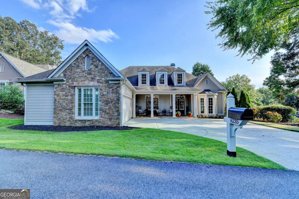 This beautiful, one-story home in the active Hampton community is designed for easy living and a vibrant lifestyle. Located just steps from the golf clubhouse, pool, and eight lighted tennis courts, you'll have endless opportunities for recreation and relaxation. Inside, you'll find a meticulously maintained, Hedgewood-built home with top-of-the-line updates. Everything from the significant systems, windows, driveway, patio, designer lighting, and so much more has been replaced. This excellent split-bedroom plan is perfect for overnight guests, offering a quality that rivals that of million-dollar homes. This is an ideal, easy living home. With every major component replaced and updated, this home offers true peace of mind. Experience the best of North Georgia living, with the North Georgia Premium Outlets, the North Georgia Mountains, and Lake Lanier all just minutes away. This is more than a home; it's a lifestyle!