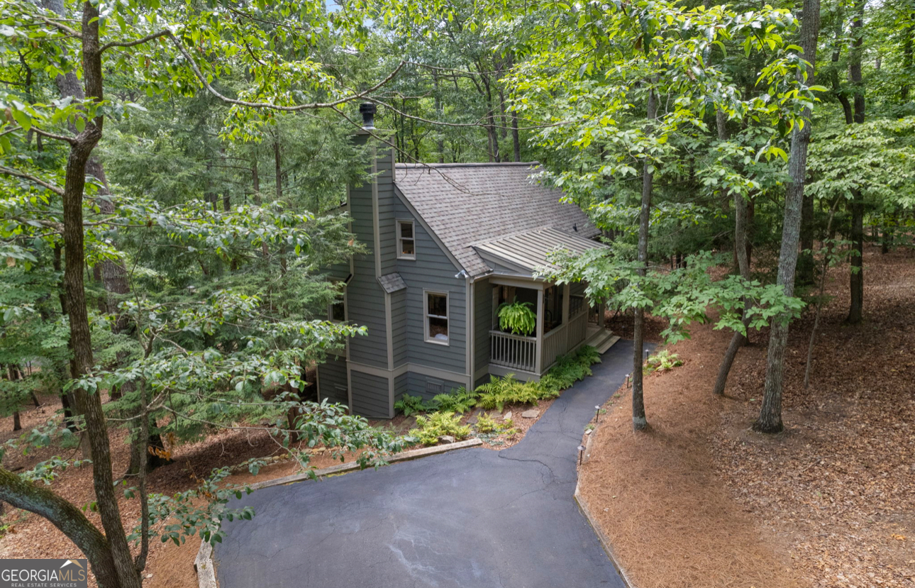 Enchanting Big Canoe Retreat: A Fairy-Tale North Georgia Mountain Escape! Every once in a while, a mountain hideaway so magical appears that you can't believe it's real-and it could be yours! Nestled like a storybook cottage amidst gentle Hemlock trees, this cabin's enchanting pathways and inviting front porch feel like it has come straight out of a fairy tale. Step inside, and a soaring stone fireplace and wide plank wood flooring instantly steal the spotlight, while a wall of sunlit windows frames your own private woodland oasis with seasonal mountain views. You'll Fall in Love With the Worry-Free Upgrades ~ HardiPlank siding, new roof, and freshly painted decks offer clean, low-maintenance peace of mind. Freshly painted interior throughout ~ Stylish & Relaxed Interiors ~ Updated baths, all new and carefully selected light fixtures, wide planked heart pine floors, contemporary new carpet in the owner's suite, double paned windows ~ Inviting kitchen with charming coffee nook, all new stainless appliances, eat-in bar and a built-in purified water dispenser. ~ Breathtaking Gathering Space ~ Striking floor to ceiling stone, wood-burning fireplace sets a cozy, dramatic focal point. A full wall of windows bathe the space in morning light-and showcase panoramic forest views. A partially open concept kitchen ensures conversation and privacy. ~ Seamless Indoor-Outdoor Living ~ Private owner's suite opens onto a screened porch-perfect for starlit evening relaxation. An expansive open-air deck stretches along the home, ideal for morning coffee or sunset unwinding. Located close to some of Big Canoe's most sought after trails and waterfalls. Imagine crisp mountain evenings, the comforting glow of a crackling fire, and birdsong drifting in. This isn't just a cabin-it's your personal forest sanctuary-perfectly refined with modern touches and timeless north Georgia mountain charm. Are You Ready to Fall in Love? Homes like this vanish fast. Big Canoe is a sought after resort like gated, mountain community with golf, tennis, pickleball, lakes, swimming, fishing, boating, hiking and a fantastic restaurant and clubhouse. It's time to move to the mountains!