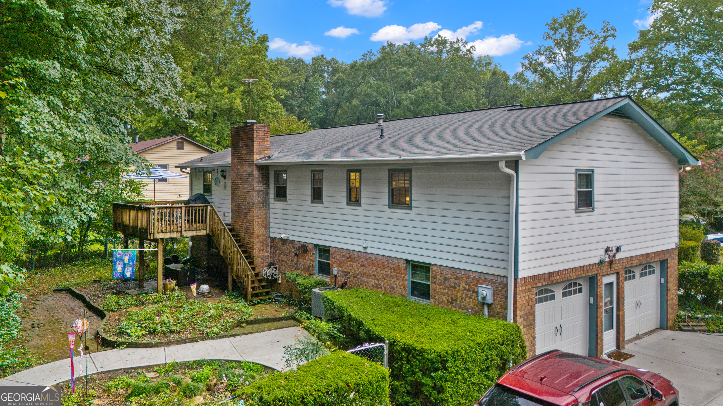This lovely home is spacious and well maintained. It is located on a nice lot with a private and fenced backyard. The deck is roomy and overlooks the partially wooded, but flat backyard. The back yard includes a storage unit for storing additional gardening tools. The driveway and sidewalk in the back yard have recently been replaced. The main floor includes the kitchen, a separate dining room, and a large vaulted great room with access to the deck. The 2nd floor includes 3 bedrooms and 2 baths, and a laundry that can accommodate a full-size washer and dryer. The basement has a den, bedroom, bathroom, and an office or work room, with its own separate entrance. This area could easily be used for a roommate or renter. The home is convenient to shopping and dining out. It is also withing walking distance of Sprayberry High School.