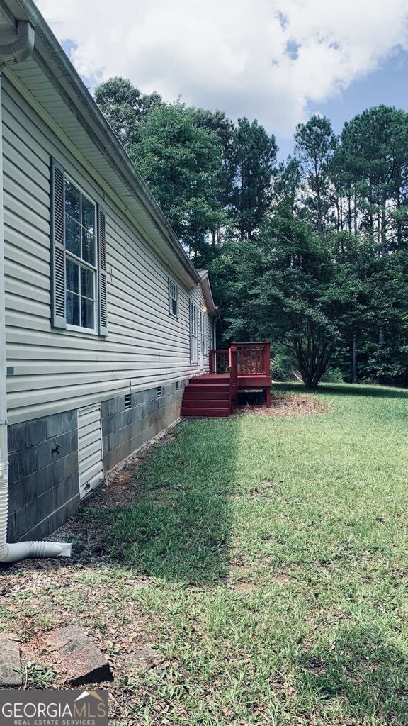 102 Bend Road, Villa Rica, GA 30180 Tucked away on a peaceful acre just outside of town, this 3-bedroom, 2-bathroom mobile home offers privacy, flexibility, and room to grow. With no HOA and plenty of outdoor space, including a large deck, a detached workshop with roll-up door, and a double carport, this property is full of potential for hobbies, projects, or simply relaxing in nature. Inside, you'll find an open living area, a light-filled kitchen with space for dining, and generously sized bedrooms. Whether you're looking for your first home, a rental opportunity, or a place to put your own stamp on, this home is waiting for your personal touches. Conveniently located in Villa Rica with easy access to shopping, dining, and I-20, this is the perfect balance of country quiet and city convenience.