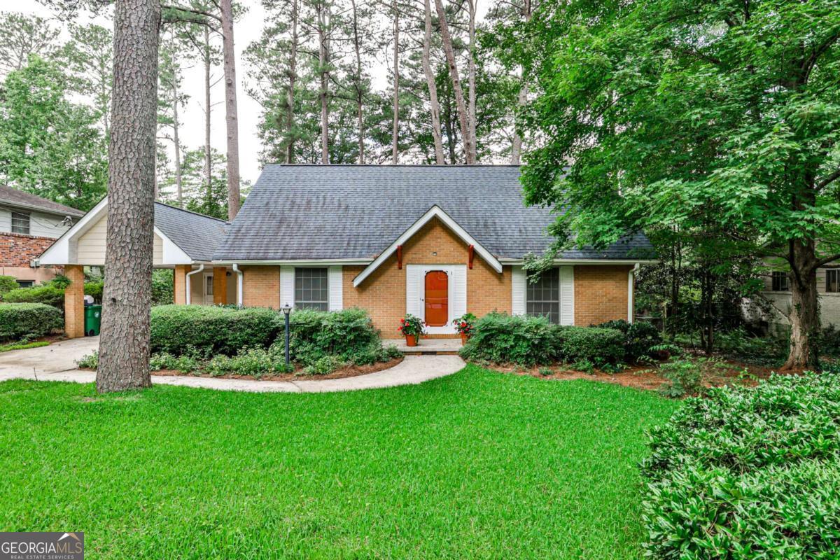 Welcome to 1338 Talcott Place, a charming and well-maintained 3-bedroom, 2-bath house on a quiet tree-lined street. Enter through the front door, to the right is the formal living room and to the left the large dining room that leads to a well-thought-out kitchen with plenty of cabinet space, casual dining area and the den. The den is open to the kitchen with built-in bookshelves and a view of the backyard. From the carport is a mudroom with laundry and access to the den as well. Also on the main level is one bedroom and bathroom. Going upstairs, there are two large bedrooms, both with their own walk-in closet with a shared bathroom. In the upstairs hallway, there is a massive closet and access to even more attic storage. The landscaped backyard is full of mature flowering plants. It is a dream to sit out and enjoy. This home is walking distance to Laurel Ridge Elementary and Druid Hills Middle School. Further away, but not by much, there is Shamrock Plaza, downtown Decatur, and so much more.