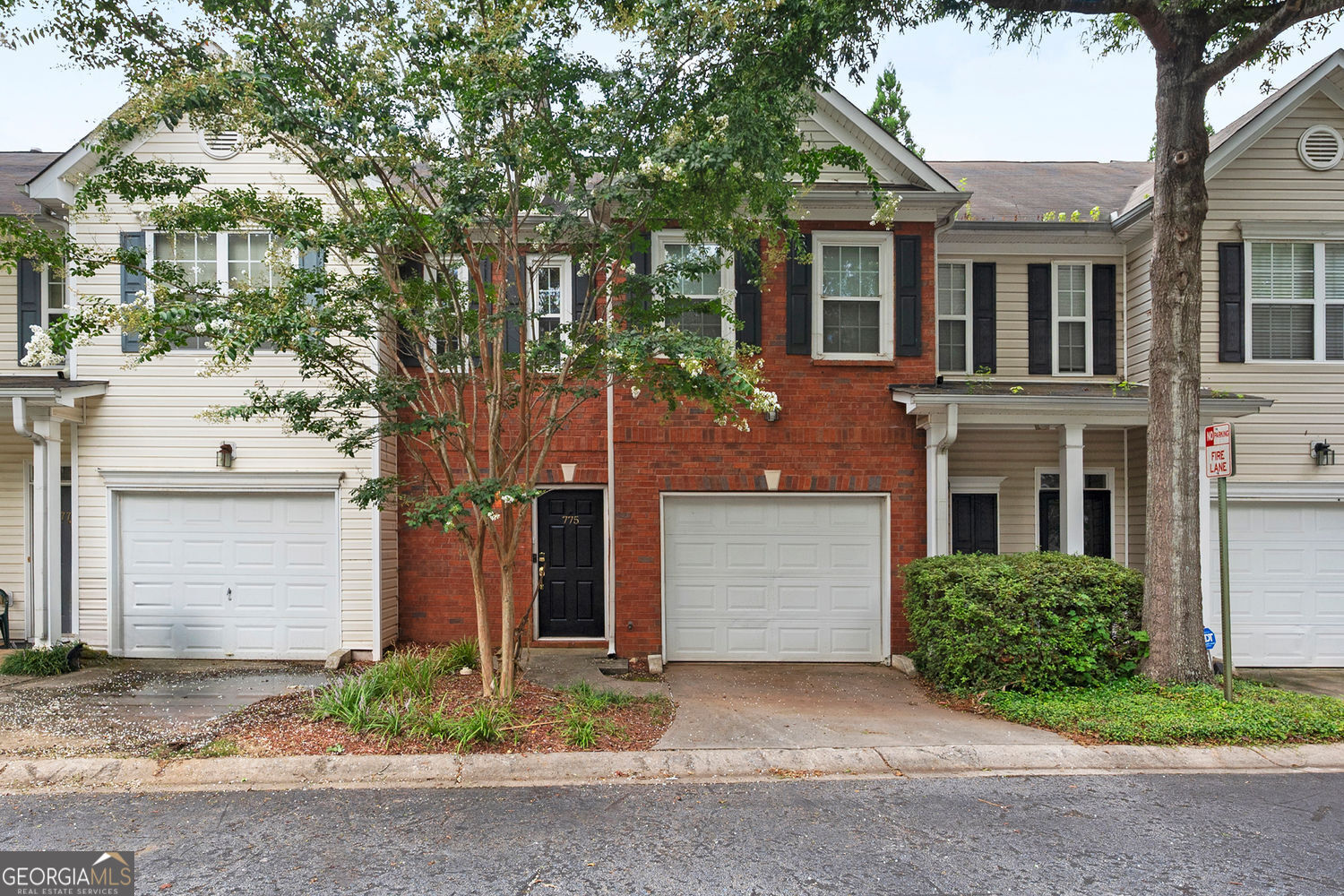 Welcome to 775 Nehemiah Lane SW-a charming two-story brick townhome that perfectly blends timeless curb appeal with smart, thoughtful upgrades throughout. From the moment you arrive, you're greeted by a manicured lawn, lush landscaping, and a vibrant tree that adds natural character to the front yard. A classic black door with gold hardware opens to light-filled living spaces, where large energy-efficient windows and a 2018-installed patio door bring the outdoors in and create a warm, inviting feel. This home is filled with updates designed for comfort, efficiency, and peace of mind. A BRAND NEW ROOF offers major value and durability for years to come. The Ring doorbell and ULTRALOQ smart lock (installed in 2017 and 2018), a 2017-updated HVAC system, and Nest thermostat deliver modern security and year-round comfort. A secondary Honeywell thermostat (added in 2019) allows personalized climate control. The attached garage, enhanced with a Chamberlain MyQ Wi-Fi Smart Hub, makes access easy-and for EV owners, a 240V charging plug is already in place. The kitchen features brand-new stainless steel appliances-refrigerator, oven, and microwave-all installed in 2024, giving you a fresh and functional cooking space from day one. The water heater, replaced in 2014, rounds out a list of quality upgrades that make this home truly move-in ready. Nestled in a well-maintained community and complete with a spacious driveway and garage, this townhome offers the perfect mix of classic charm and modern-day ease. Schedule your private tour today-this meticulously cared-for home won't last!