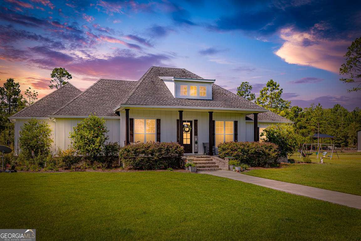 Welcome to 465 Old Brookman Rd - a stunning private estate, custom-built by it's one owner. This Low Country residence is situated on 4.5 private, gated acres offering immense land to expand or explore! This 3,855 sq. ft. residence offers 5 spacious bedrooms, 3.5 baths, and an inviting floor plan that perfectly balances elegance and livability. The main features a foyer that is open to the formal dining, great room, and chef's kitchen with beautiful quartz and custom cabinetry. The main also features 4 bedrooms with 3 full baths and a half bath, including a relaxing screen porch over looking the pool. Upstairs is a large bonus, or office, which would make for a 5th bedroom en suite with full bath! Inside, you'll find luxury vinyl flooring throughout, detailed crown molding, recessed lighting, & quartz counter tops and many more upgrades. Exterior features include a sparkling saltwater pool, huge paver patio, and expansive grounds that provide plenty of space for RVs, boats, and extra parking, even space for a storage adding convenience, while the gated entrance ensures peace and seclusion. With no HOA, you'll enjoy the freedom to truly make this property your own. Built for modern living, this home is equipped with a powerful 26kW generator, a Carrier 20.5 SEER communication HVAC system, and (2) 50-gallon Bradford White water heaters for efficiency and reliability. With timeless Low Country charm, privacy, and every thoughtful upgrade, 465 Old Brook Rd offers the best of both luxury and lifestyle.