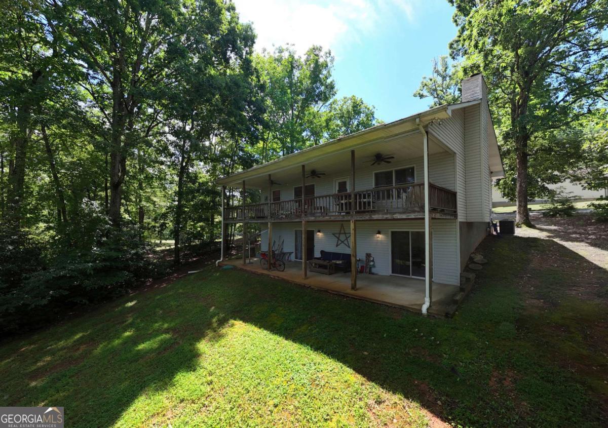 Experience the best of lake and mountain living at 97 Windjammer Drive! Prepare to fall in love with this charming 3-bedroom, 3-bath home offering mountain views and beautiful views of Lake Chatuge right from your backyard. Perfectly situated in a lakeside neighborhood, this home combines peaceful surroundings with close proximity to downtown Hiawassee and local attractions. The main level boasts an open-concept layout with hardwood floors, soaring ceilings, and a cozy wood-burning fireplace that adds warmth and character. The updated kitchen features stainless steel appliances, a breakfast bar, and plenty of space for cooking and entertaining. The main floor also includes a spacious master suite and a guest bedroom, with serene lake views visible from the covered deck-ideal for morning coffee or evening relaxation. The finished lower level expands your living space with a generous bonus room, a third bedroom, full bath, laundry area, and a versatile workshop/storage room-perfect for hobbies or additional storage. Whether you're looking for a full-time residence or second home, this move-in ready, turn-key property is a must-see.