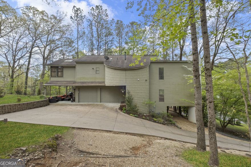 Own your own architectural sanctuary home in the Walton High School district! This unique home in Lake Fjord sits on a beautiful corner lot, offering tranquility, and panoramic views. Inside, enjoy gorgeous oak and Brazilian cherry floors, Turkish porcelain tiles, and soaring ceilings with abundant natural light. The great room features a vaulted ceiling with exposed beams, and a wood-burning fireplace. The adjacent dining room overlooks the great room and connects to a large screened-in porch. The gourmet kitchen boasts Sub-Zero and Jenn-Air appliances, a double oven, warming drawer, island seating, and a breakfast nook with a barn wood accent wall. Upstairs, the spacious primary suite has a sitting room,two large walk-in closets, and private access to its own cedar hot tub room. The bathroom has a free standing Oceania deep soaking tub, dual vanities, and a separate shower. Two additional bedrooms, a full bath, and a large laundry room complete the upper level. The finished terrace level includes a finished bedroom, full bath, and a recreation/family room with exterior entry and parking perfect for an in-law or au pair suite. The backyard is cleared, leveled, and landscaped, ready for playtime. Don't miss the virtual tour!