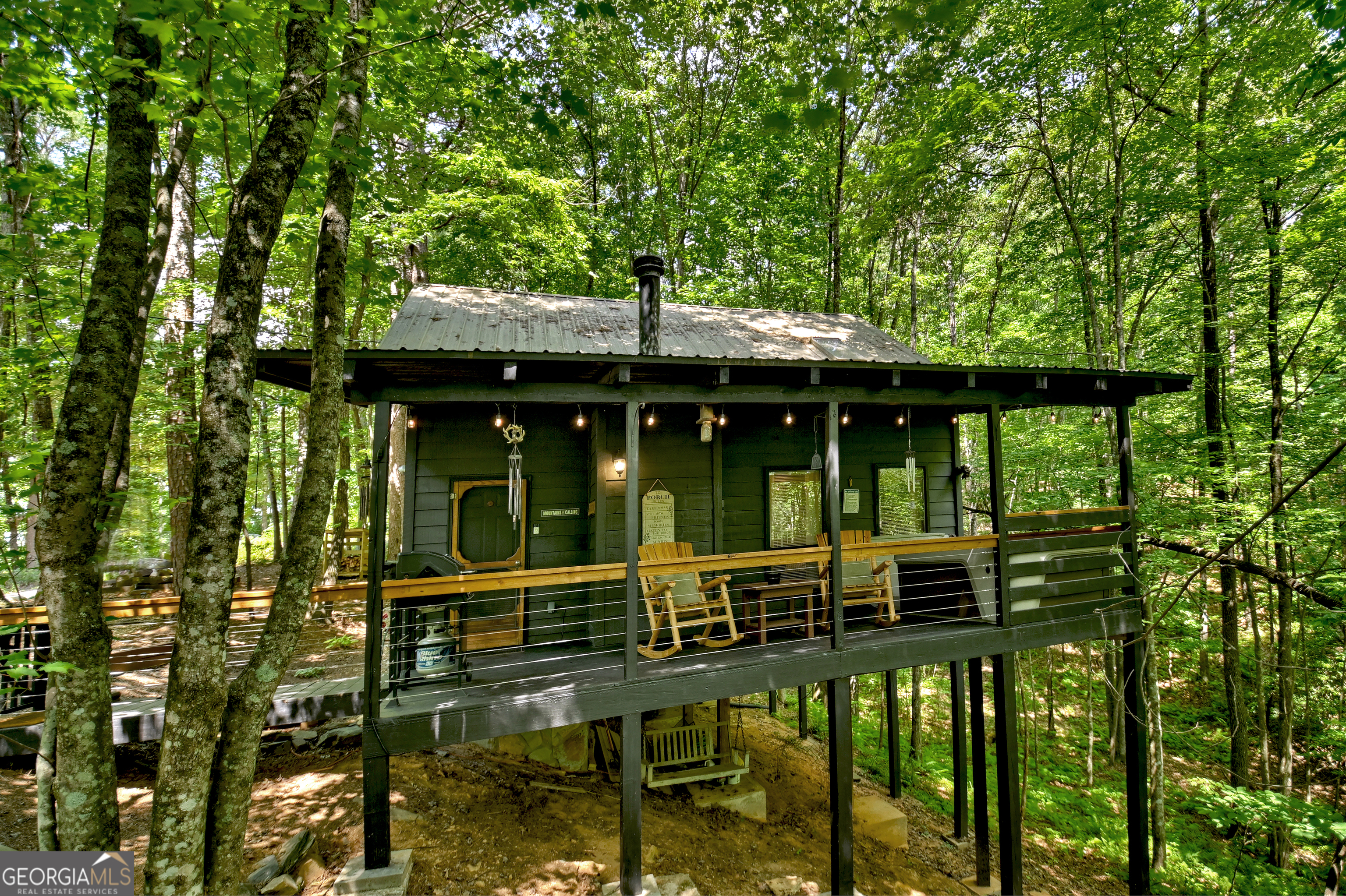 Charming Rustic Cabin Retreat - Your Perfect Mountain Getaway! On track to gross $60K+ this year! Nestled on a serene **1-acre lot** just minutes from **downtown Blue Ridge**, this cozy **1-bedroom, 1-bathroom** cabin offers the ultimate escape with modern comforts and rustic charm. Perfect as a personal retreat, investment property, or both-this cabin is an **active short-term rental** and comes **fully furnished** for a seamless transition. Step inside to discover an inviting open-concept living space, complete with warm wood finishes, a classic **wood-burning fireplace**, and tasteful rustic decor. The highlight of this retreat is the outdoor hot tub, where you can relax year-round in total privacy. Outdoor living is just as appealing, with a covered **porch** perfect for morning coffee, a charming **fire pit** area for roasting s'mores under the stars, and ample room to explore or entertain on the spacious property. Enjoy the best of both worlds-secluded, peaceful living surrounded by nature while being just a short drive to Blue Ridge's restaurants, shopping, and outdoor activities. Whether you're looking for a **turnkey investment** or your own mountain sanctuary, this cabin is a rare gem you won't want to miss!