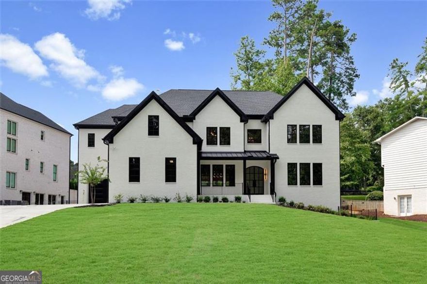 Impressive New Construction home located in East Cobb's coveted Walton High School district.  This home features custom finishes and upgrades throughout, including - ANDERSON WINDOWS, SPRAY FOAM ISOLATION, METAL DOOR AND RAILING and a COVERED DECK with fireplace and stairs leading to a large backyard, which offers plenty of privacy and space for a future pool.  This floor plan is perfect for families and includes an ADDITIONAL  Master Bedroom, laundry and SCULLERY all on the Main Floor. Custom cabinetry and quartz countertops throughout the house with a kitchen that features height quartz backsplash and waterfall legs for the island, along with Thermador appliances. The open Second Floor features a Master Bedroom, laundry, media room, and three spacious secondary bedrooms, all with their own walk-in closets and full baths.  The Master Bedroom on the second level offers an abundance of space with its spa-inspired bath with soaking tub, frameless glass shower door, dual vanities and a large his and hers closet.  The FINISHED BASEMENT includes a large bedroom with its own bathroom and closet along with space for a second office, kitchen, gym and theater. The three-car garage also includes wiring for an ELECTRIC CAR CHARGER. Quick and easy access to I-75 in one direction and an abundance of popular retailers, restaurants and shops.