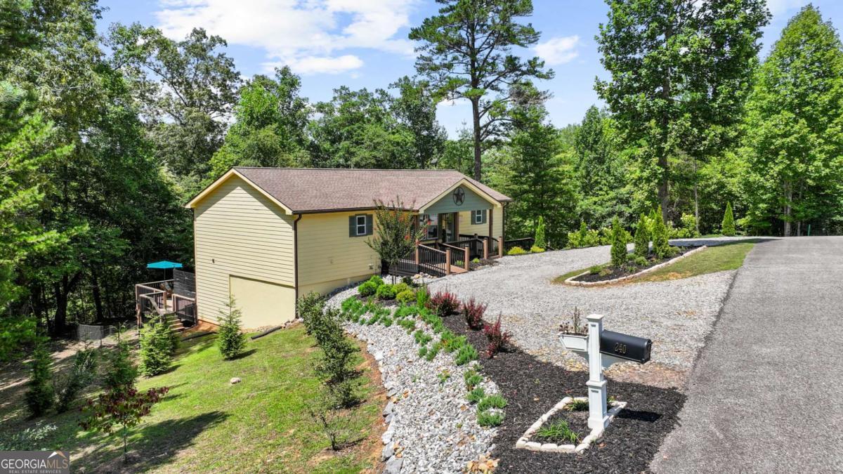 Why Wait for New Construction? This 2023 home Has It All - And Then Some! Say hello to easy, breezy living in this better-than-new primary on the main-style retreat that checks every box. Primary on main? Check. Guest suite on main? Yep. Custom walk-in closets? Oh yes. But wait, there's more. Kick back in the massive screened-in porch that stretches across the back of the house. Or head downstairs to the private lower-level suite that opens straight onto a huge deck, patio, and your very own HOT TUB oasis. Hosting just got an upgrade. Got toys? Tools? A hobby that needs space? You'll love the oversized 2-car garage, circular drive, and extra driveway access to the lower level. Bonus office or flex space, stylish LVT flooring throughout, gorgeous granite countertops, and tasteful upgrades in every corner. No HOA. No traffic. No noise. Just peace, quiet, and the convenience of being just minutes from town, Meeks Park, hiking trails, fishing spots, and the lake. Small community vibes, big lifestyle energy. Come see why this isn't just a home, it's the one.