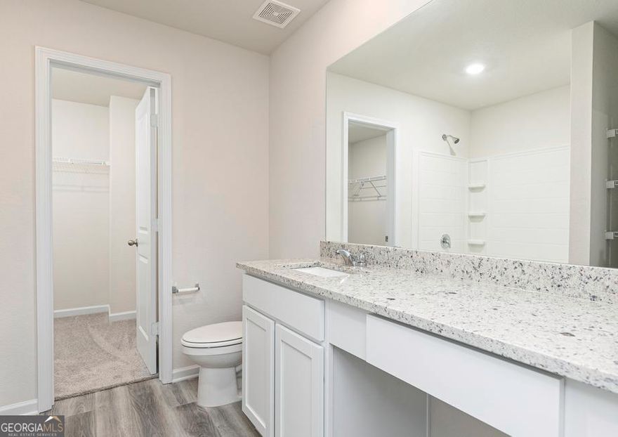 Welcome Home to the Avery at Lake Preserve at Jackson Trail    Step inside the Avery by LGI Homes-a warm and inviting two-story retreat designed with Southern comfort and modern living in mind. This charming 3-bedroom, 2.5-bathroom home blends open-concept living with private upstairs spaces, creating the perfect balance for both entertaining and unwinding.    Made for Gatherings and Good Times    Whether you're hosting Sunday supper or cheering on your favorite team, the Avery makes every moment feel special. The bright, open layout flows effortlessly from the spacious family room to the upgraded kitchen, where you'll find gleaming granite countertops, energy-efficient Whirlpool stainless steel appliances, and a center island made for conversation. Step out to the covered back patio to sip your morning coffee or enjoy an evening breeze with neighbors and friends.    Your Private Master Retreat    Upstairs, serenity awaits. The master suite is your personal escape, featuring a beautifully appointed bathroom with a dual tub and shower, an added linen closet, and an expansive walk-in closet ready to keep everything in its place. Sunlight pours through the large window, creating a peaceful, airy atmosphere that's all your own.    Room to Grow and Play    Two additional bedrooms provide plenty of space for family, guests, or a home office, while the spacious upstairs loft offers endless possibilities-turn it into a cozy reading nook, a home gym, or a fun game room for movie nights and memories.    The CompleteHomeTM Touch    Every detail of the Avery shines with LGI Homes' CompleteHomeTM interior package-bringing together designer finishes, energy-efficient technology, and quality craftsmanship at no additional cost.    Community Charm    Life at Lake Preserve at Jackson Trail is as sweet as sweet tea on a summer afternoon. Enjoy strolls by the neighborhood pond, weekend picnics at the playground, and easy access to nearby dining and shopping. With a true sense of community and peaceful surroundings, this is where Southern living meets everyday comfort.    Come on home to the Avery-where life is beautiful, easy, and built to be lived well.