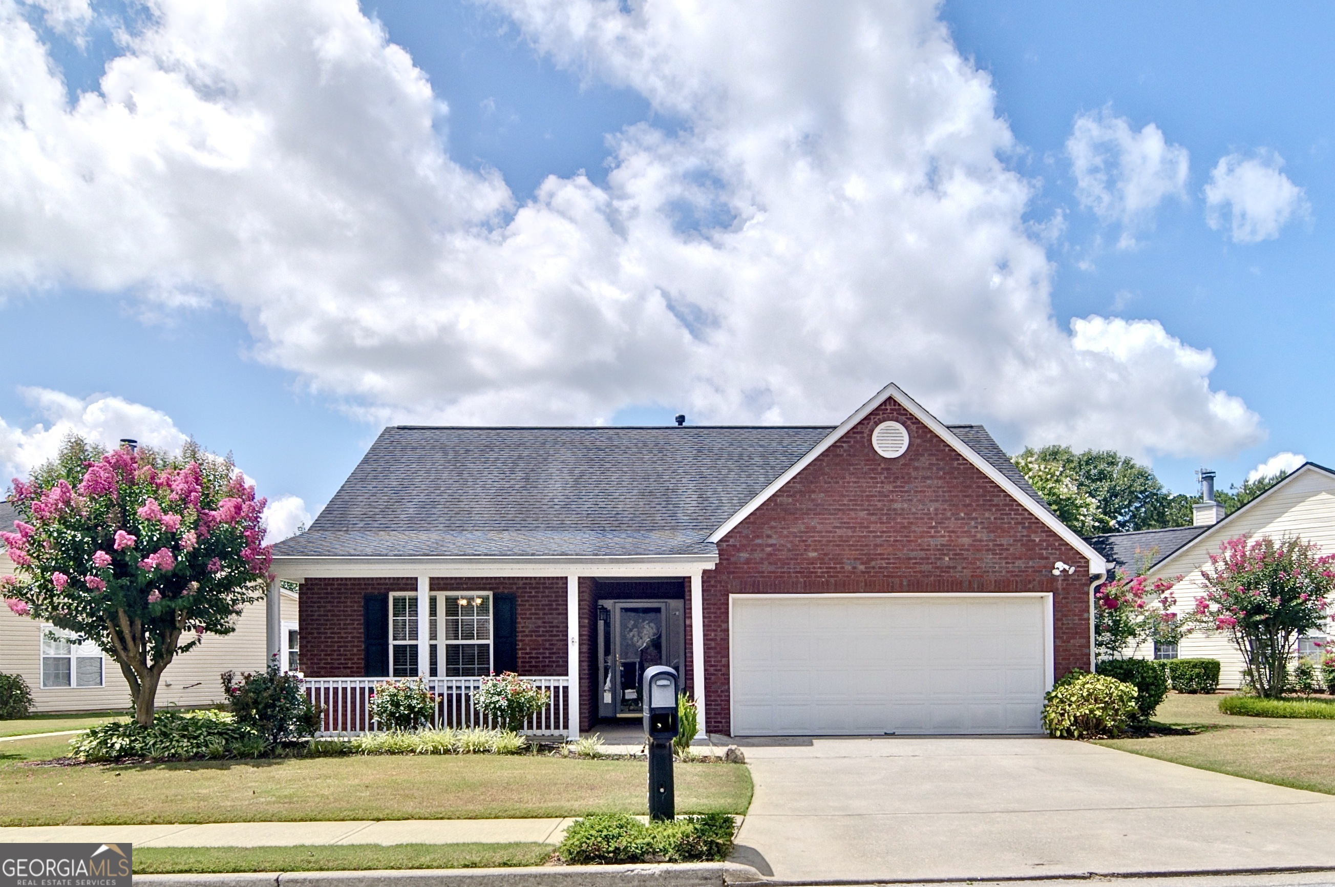 Charming Brick-Front Ranch in 55+ Community! Welcome home to this beautifully maintained 2 bedroom, 2 bath ranch, nestled in a sought-after 55+ community. With a stepless foyer entry and desirable split bedroom floor plan, this home offers comfort, convenience, and privacy. Step into a spacious family room with vaulted ceilings and an abundance of natural light. The white, bright kitchen features plentiful cabinetry, a breakfast bar, and a stylish tiled backsplash - perfect for both casual dining and entertaining. A separate laundry room adds everyday ease. The oversized owner's suite boasts a large walk-in closet and a tiled ensuite bath. The secondary bedroom and full bath are thoughtfully located on the opposite side of the home, ideal for guests or a home office. Enjoy fresh air on the covered front porch or relax in the backyard overlooking the peaceful community gazebo and courtyard. You'll also love the mature, vibrant landscaping, blueberry bushes, and colorful flowers that surround the home. Additional highlights include brand new LVP flooring, tile flooring in both bathrooms, and a spacious 2-car garage with extra storage. This move-in ready gem offers low maintenance living in a friendly, well-kept community - don't miss your chance to make it yours!