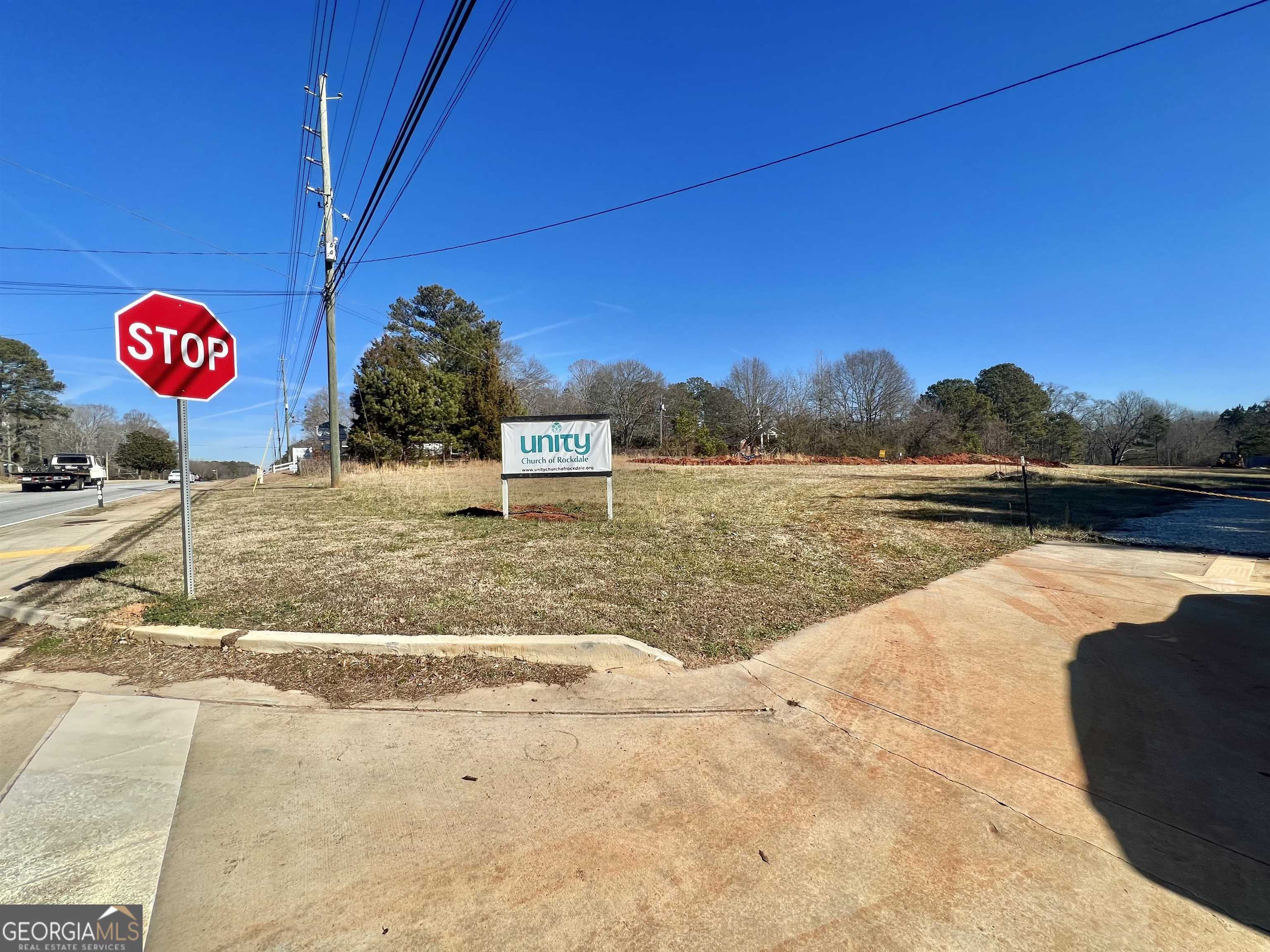 GDOT approved and finalized 14.87 acres with highway entry. Installed storm drains. Inner drive, parking and septic system approved by Rockdale county. Beautiful mature treed acres in back of land for immediate enjoyment. Unlimited possibilities abound with this unique opportunity in the thick of the action on a busy thoroughfare. Five minutes from Target/Publix shopping center.Restaurants, banking, and shopping galore. Just 5 miles from I-20.