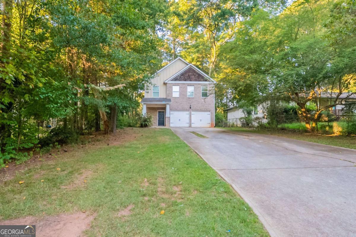 Inviting two-story traditional home in Decatur's Hillsides neighborhood. This residence features hardwood floors throughout the main level, a comfortable family room with fireplace, and a kitchen with breakfast bar overlooking the living area. The primary suite offers a walk-in closet and bath with dual sinks, soaking tub, and separate shower. Upstairs, additional bedrooms provide plenty of space for family or guests, while the level lot offers a spacious yard for outdoor enjoyment. With its convenient location near Candler Road, shopping, dining, and quick access to I-20, this home blends everyday comfort with easy accessibility.