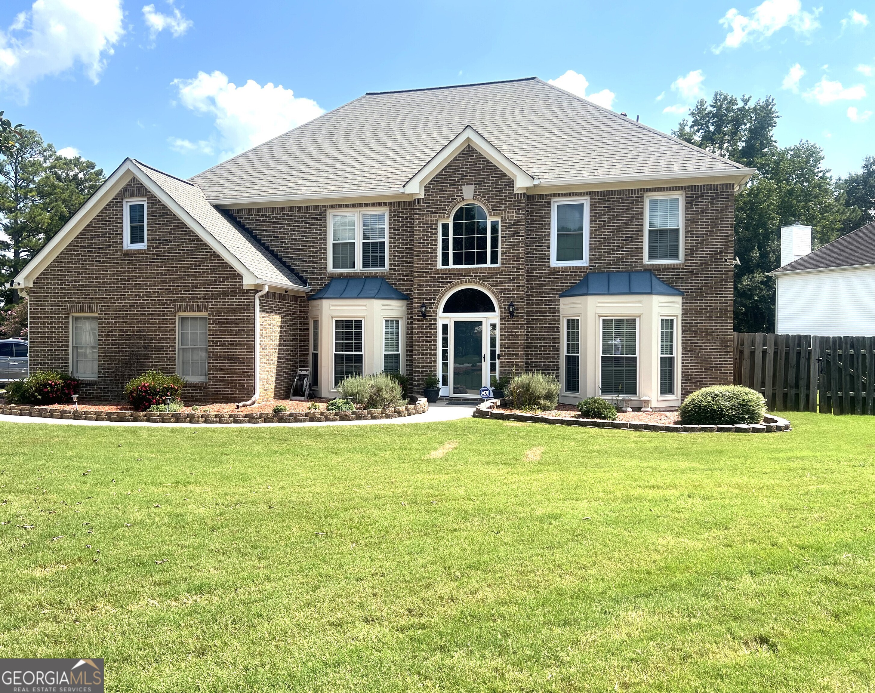 Look no further! This meticulously maintained gem is a place you can call home. Tucked away on a prime corner lot in the heart of Fayetteville, this charming 2-story home exudes warmth, style and a perfect blend of classic features with modern upgrades. Step inside, and you'll be captivated by the grand entrance that greets you with a striking split staircase, setting the tone for the spacious and thoughtfully designed layout. The sunken family room is the heart of the home. By day natural light pours in through the large windows, highlighting the beautiful hardwood floors that flow throughout the main level and by night cozy evenings near the fireplace invite you to relax and unwind. For those who love to entertain, the formal living and dining rooms offer sophisticated spaces for family gatherings or intimate dinner parties. The upgraded kitchen is a chef's dream-featuring solid surface countertops, gas cooktop, double ovens and a breakfast bar for casual dining. The spacious eat-in area is perfect for enjoying meals with family or friends while taking in views of the private backyard. Speaking of the backyard, the sunroom provides an ideal spot to unwind, with an abundance of natural light and serene views of the privately fenced yard, it's just the right setting for morning coffee or a quiet afternoon read. Upstairs, you'll find an exceptional primary suite designed with your comfort in mind. The spacious retreat offers a spa-like bath with double vanity, new clawfoot tub, separate new shower, and a generous walk-in closet. It's the perfect space to dream, refresh and rejuvenate at the end of a busy day. You'll also enjoy community amenities, easy access to shopping, dining, and entertainment options. Don't miss your chance to experience all this property has to offer. Contact me today to schedule your private tour!
